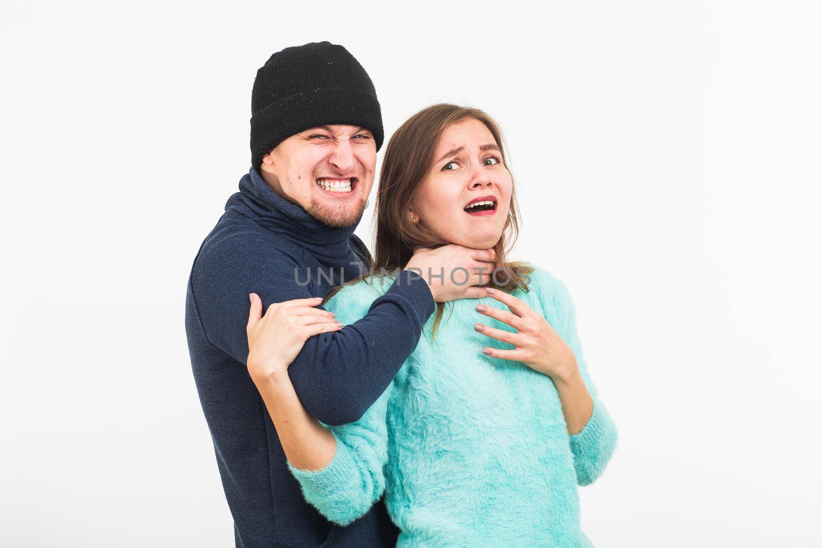 Woman victim of violence and abuse. Criminal man beats a woman on white background by Satura86