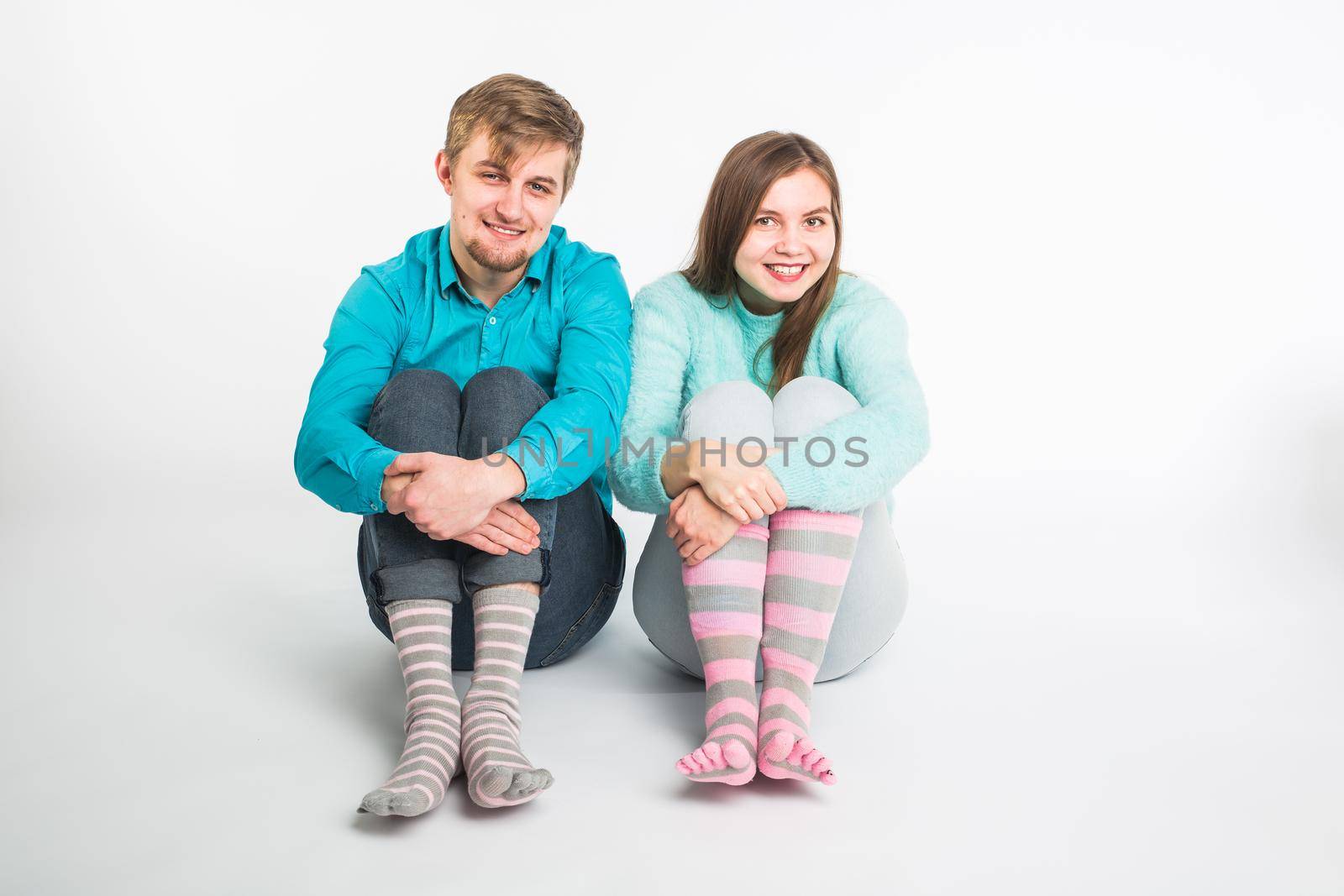 Portrait funny moments of excited couple fooling around to camera on white background. Having fun, weekends and valentines day concept.