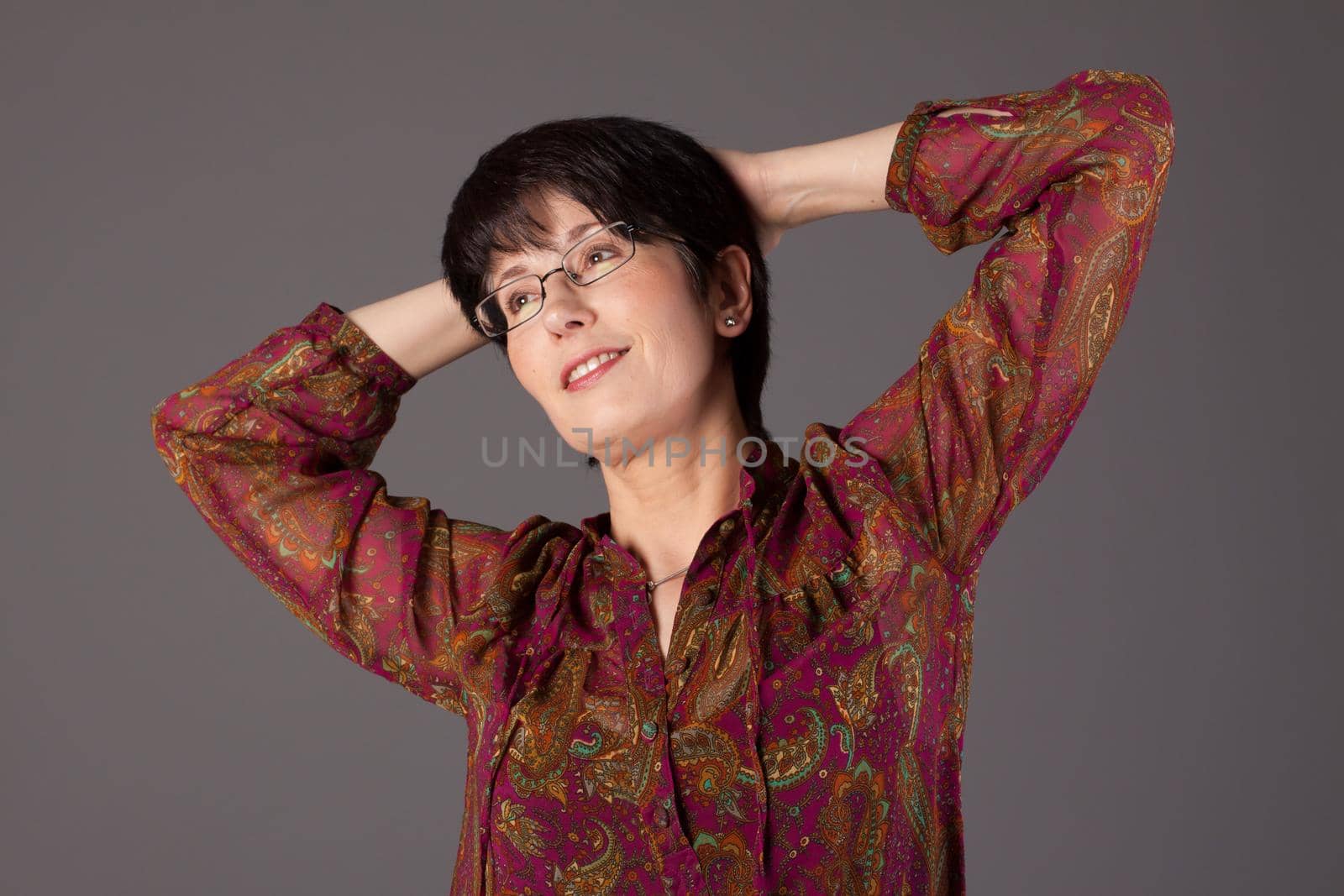 Elegant middle aged woman posing with woolen warm scarf