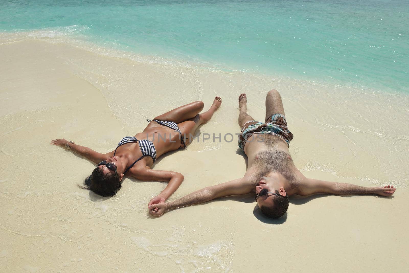 happy young romantic couple in love have fun and relaxing on beautiful beach