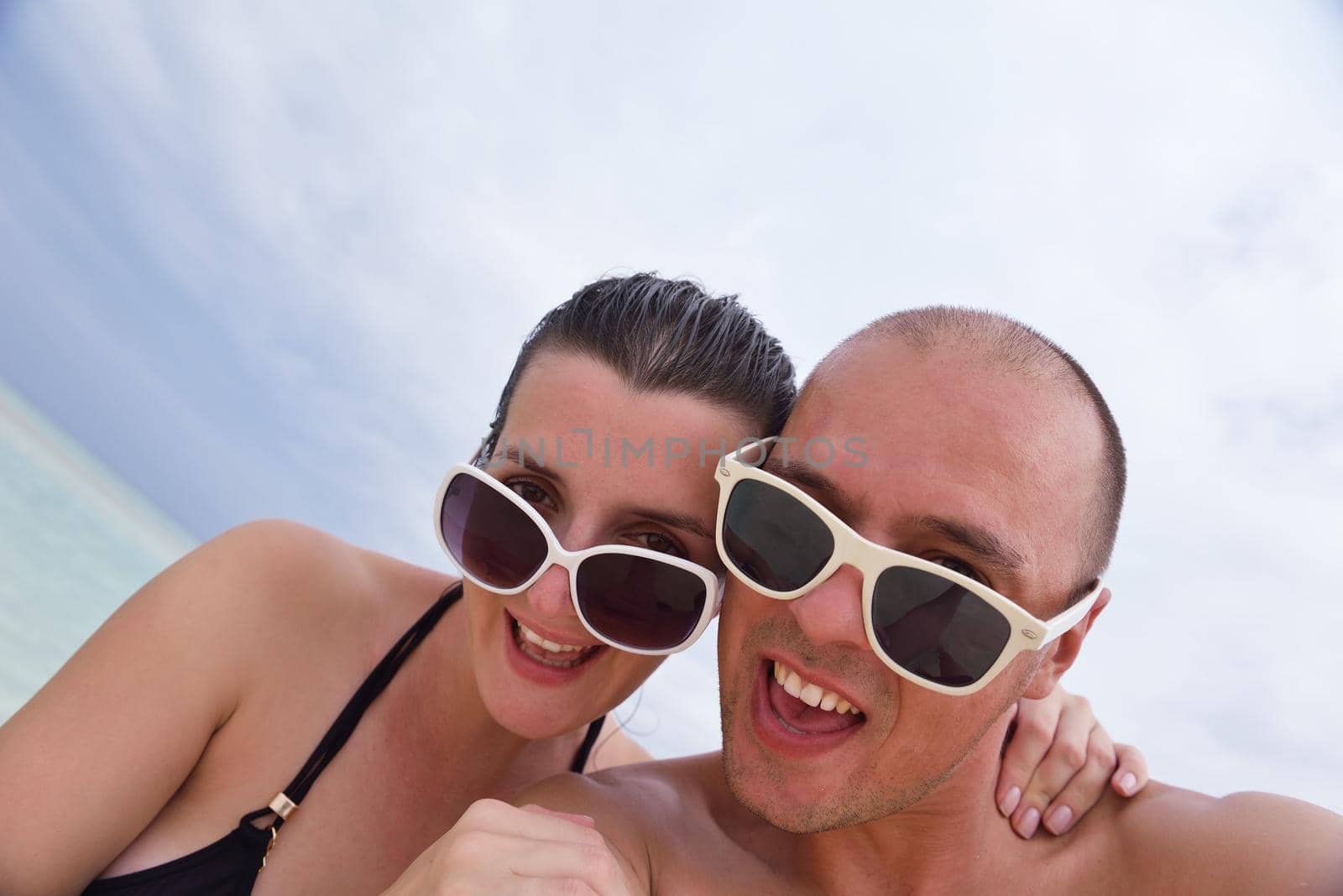 happy young  couple at summer vacation have fun and relax at beautiful sunny  day on beach