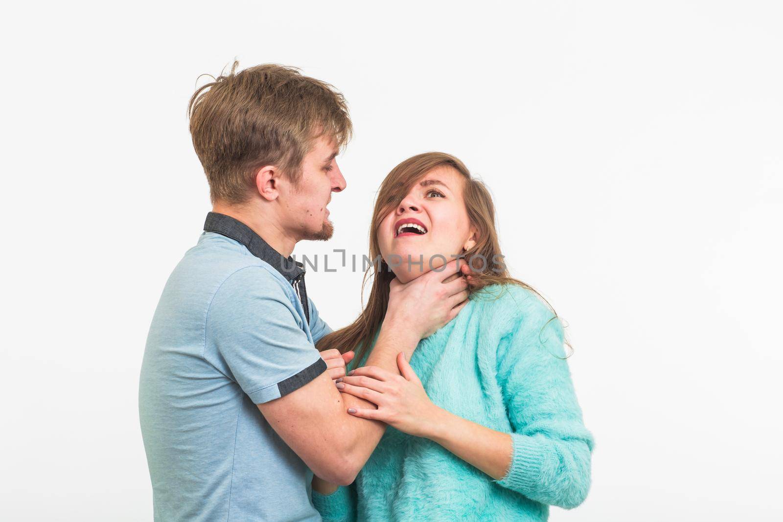 Woman victim of domestic violence and abuse. The quarrel in the family. A man beats a young woman on white background by Satura86