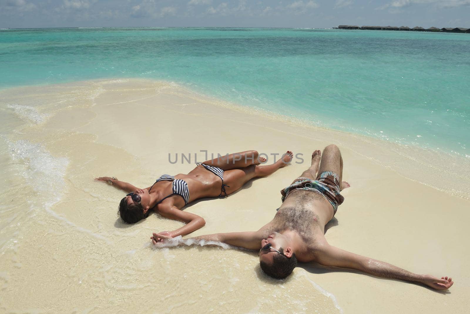 happy young romantic couple in love have fun and relaxing on beautiful beach