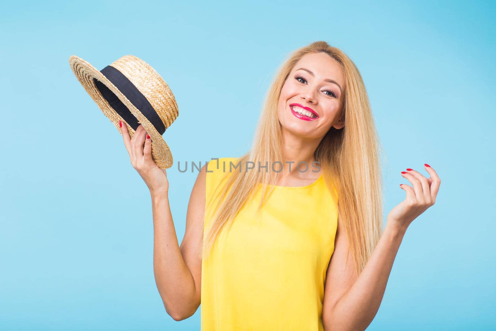 Portrait of smiling blonde woman in fashionable look on blue background. Style, fashion, summer and people concept by Satura86