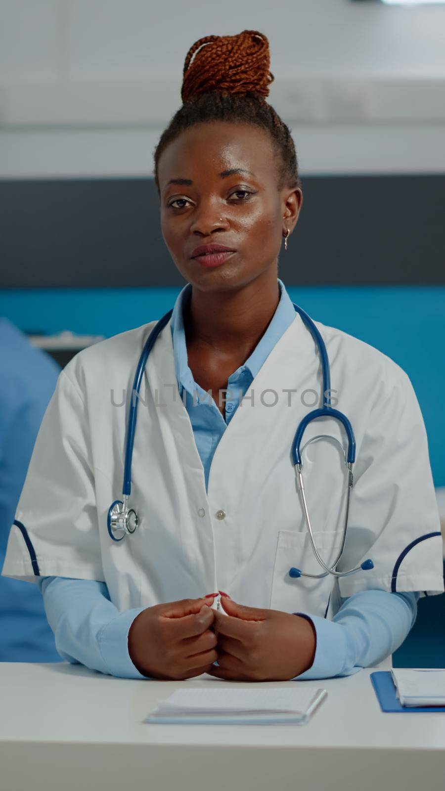 Black medic on video call online conference sitting at desk in medical cabinet. African american doctor using remote communication method on internet for telemedicine treating people