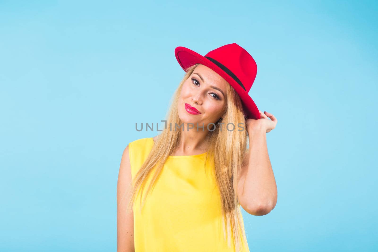 Portrait of happy cheerful smiling young beautiful blond woman on blue background by Satura86