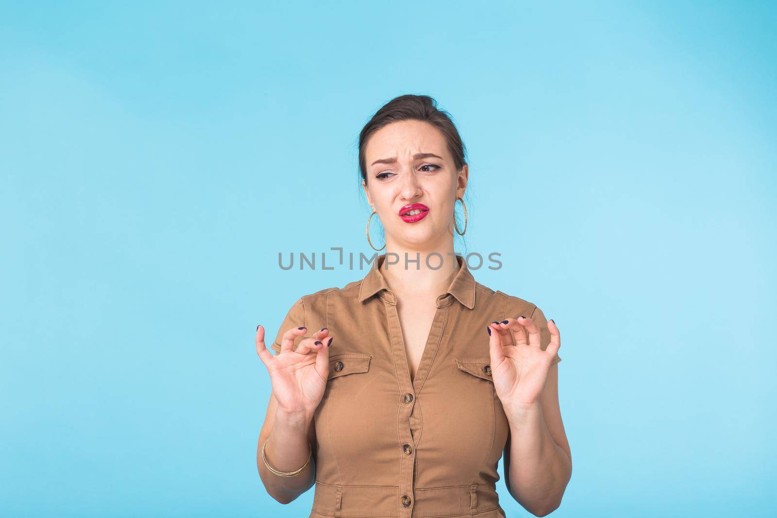 Portrait of young emotional woman cheerful smiling looking at camera. Isolated on pastel blue background. Copy space. by Satura86