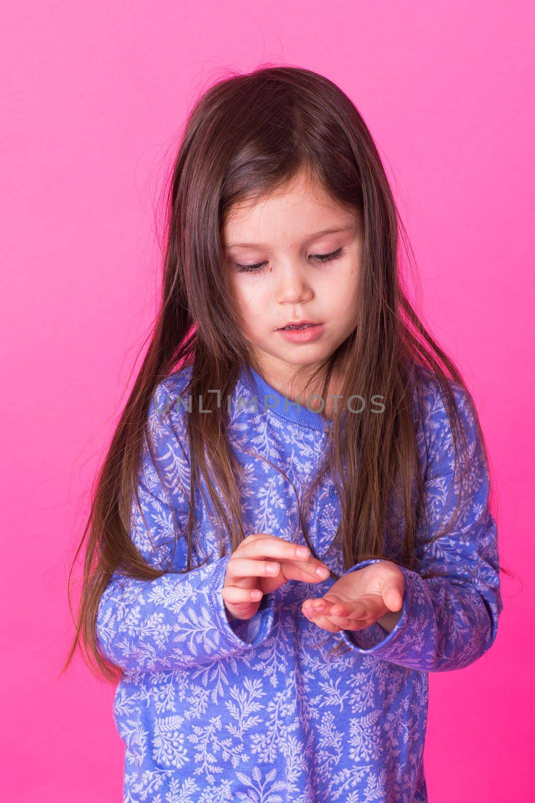 Pretty cute little girl on pink background