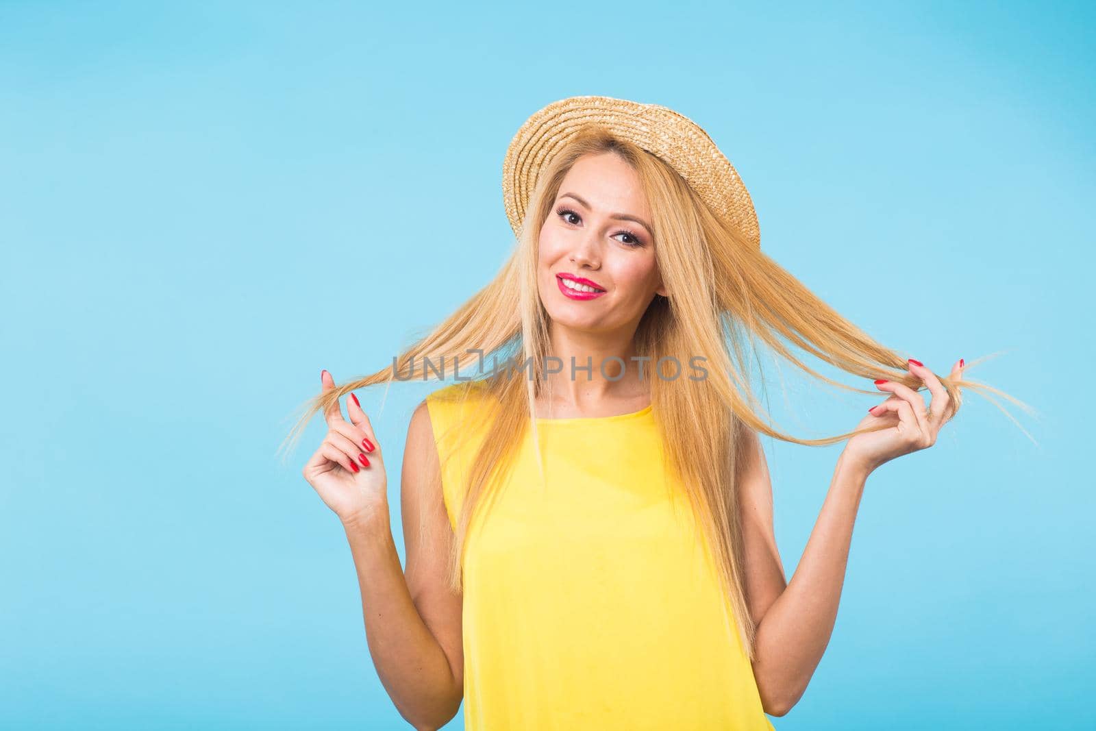 Portrait of happy cheerful smiling young beautiful blond woman on blue background by Satura86