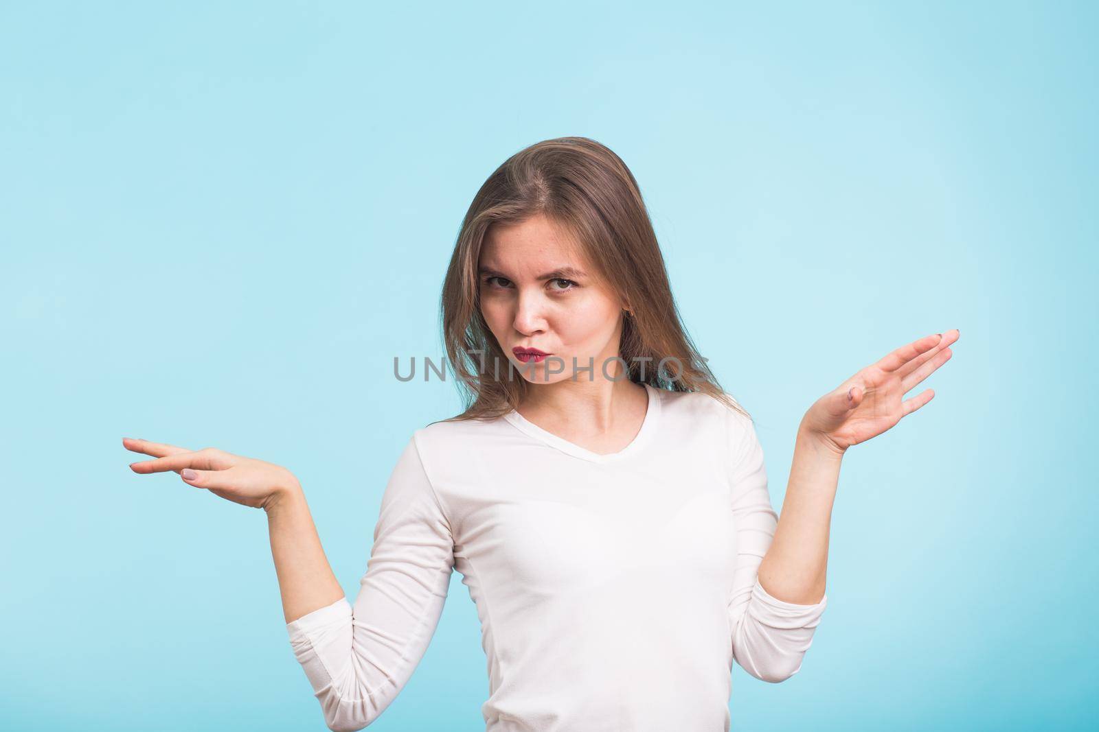 Energy girl dances on blue background in studio