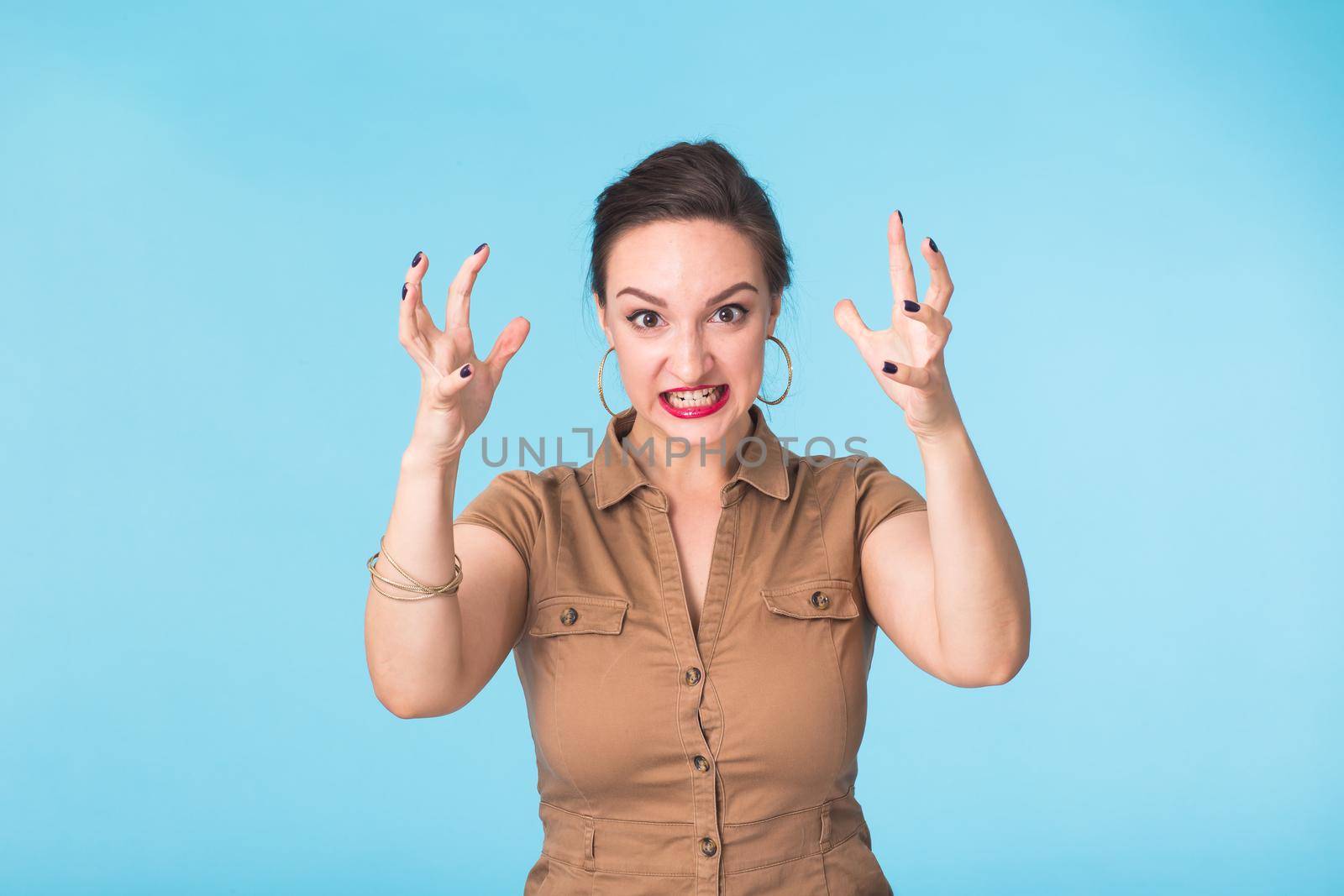 Portrait of young emotional woman cheerful smiling looking at camera. Isolated on pastel blue background. Copy space. by Satura86