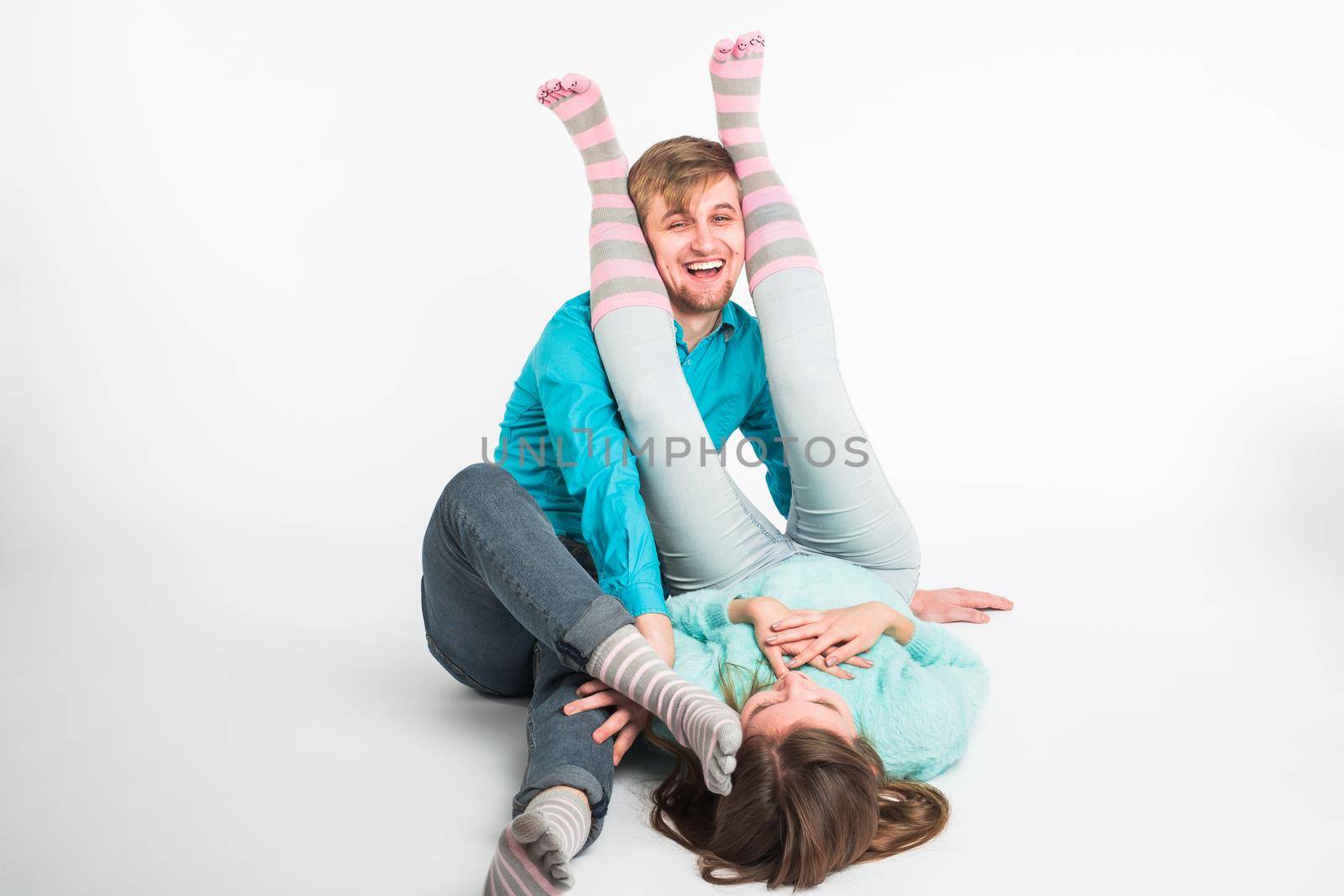 Portrait funny moments of excited couple fooling around to camera on white background. Having fun, weekends and valentines day concept.