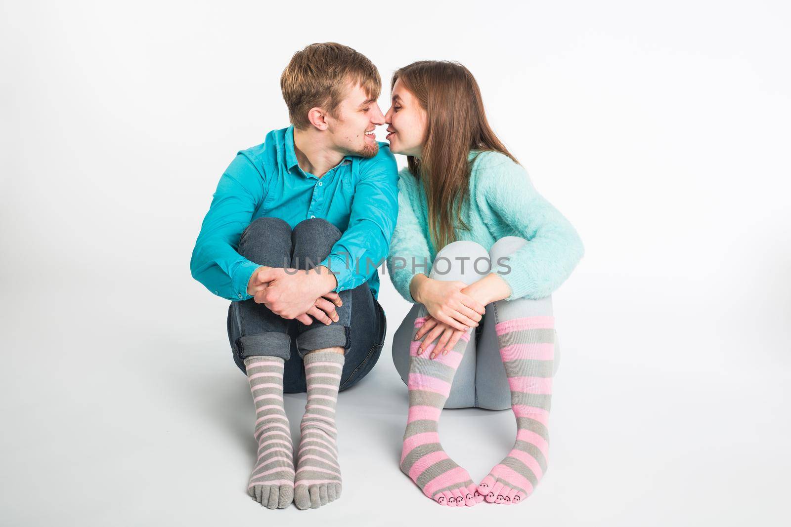 Portrait funny moments of excited couple fooling around to camera on white background. Having fun, weekends and valentines day concept.