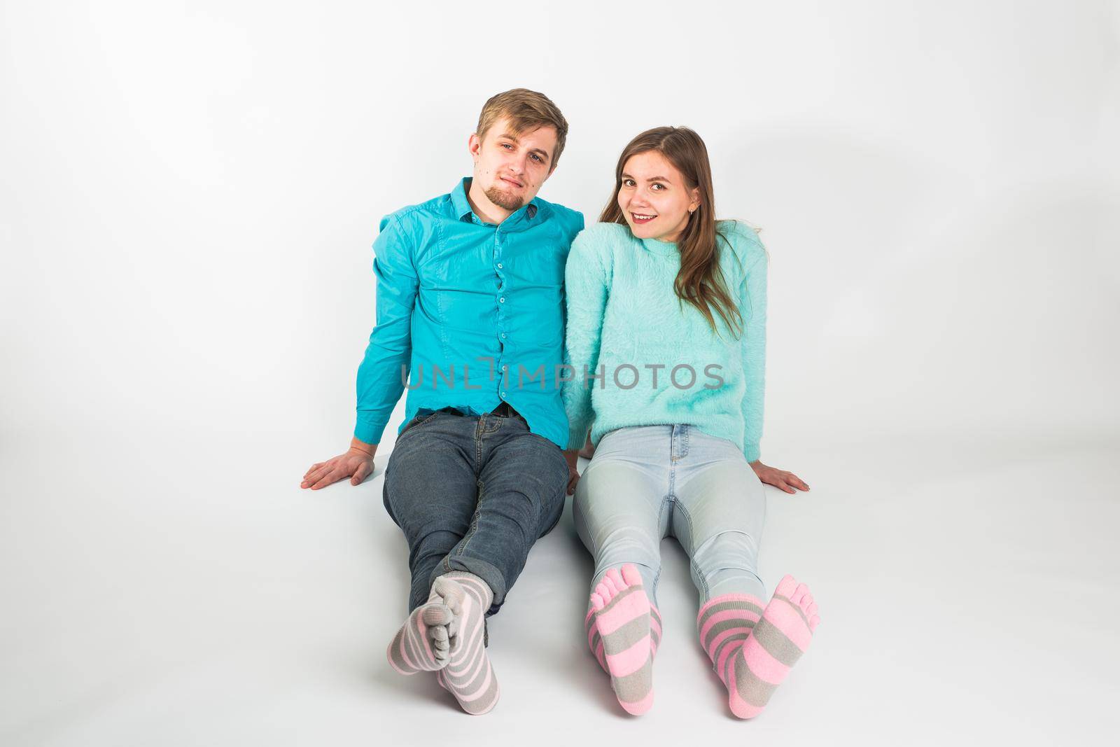 Portrait funny moments of excited couple fooling around to camera on white background. Having fun, weekends and valentines day concept.