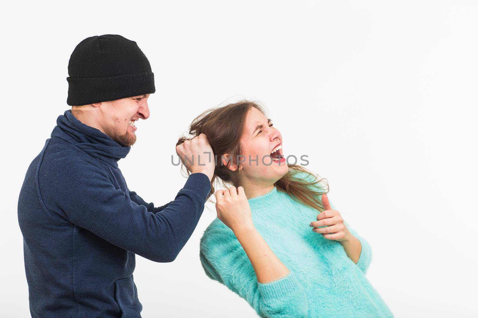 Woman victim of violence and abuse. Criminal man beats a woman on white background by Satura86