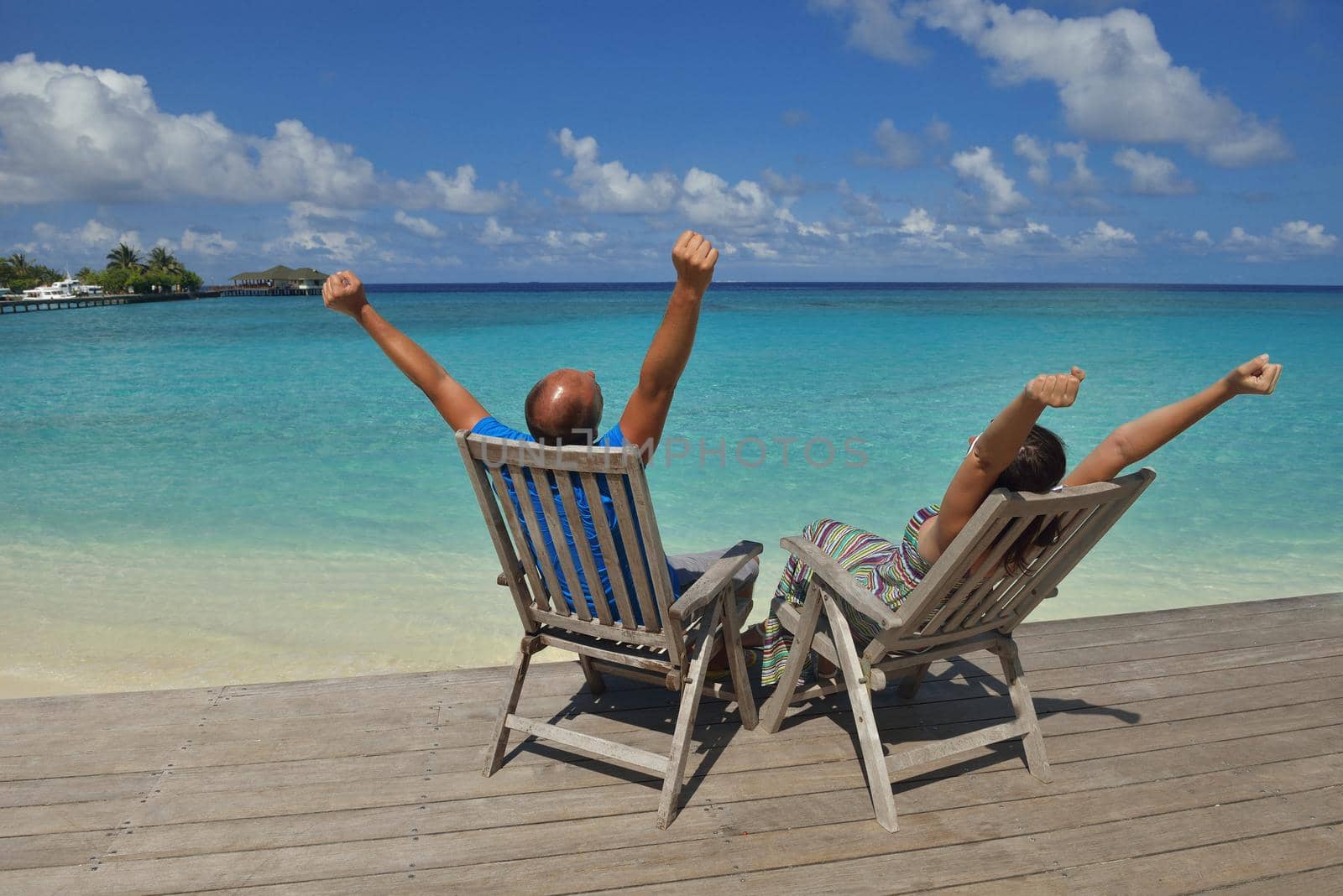 happy young couple have fun on beach by dotshock