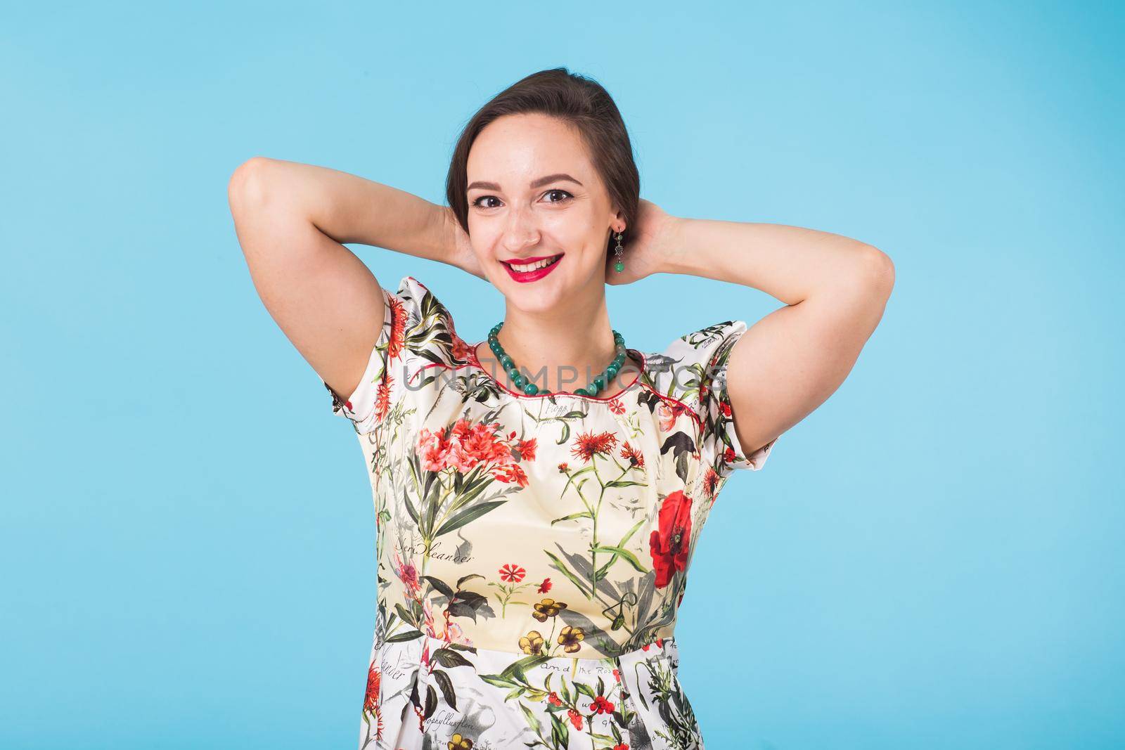 Portrait of young beautiful woman cheerfuly smiling looking at camera. Isolated on pastel blue background. Copy space. by Satura86