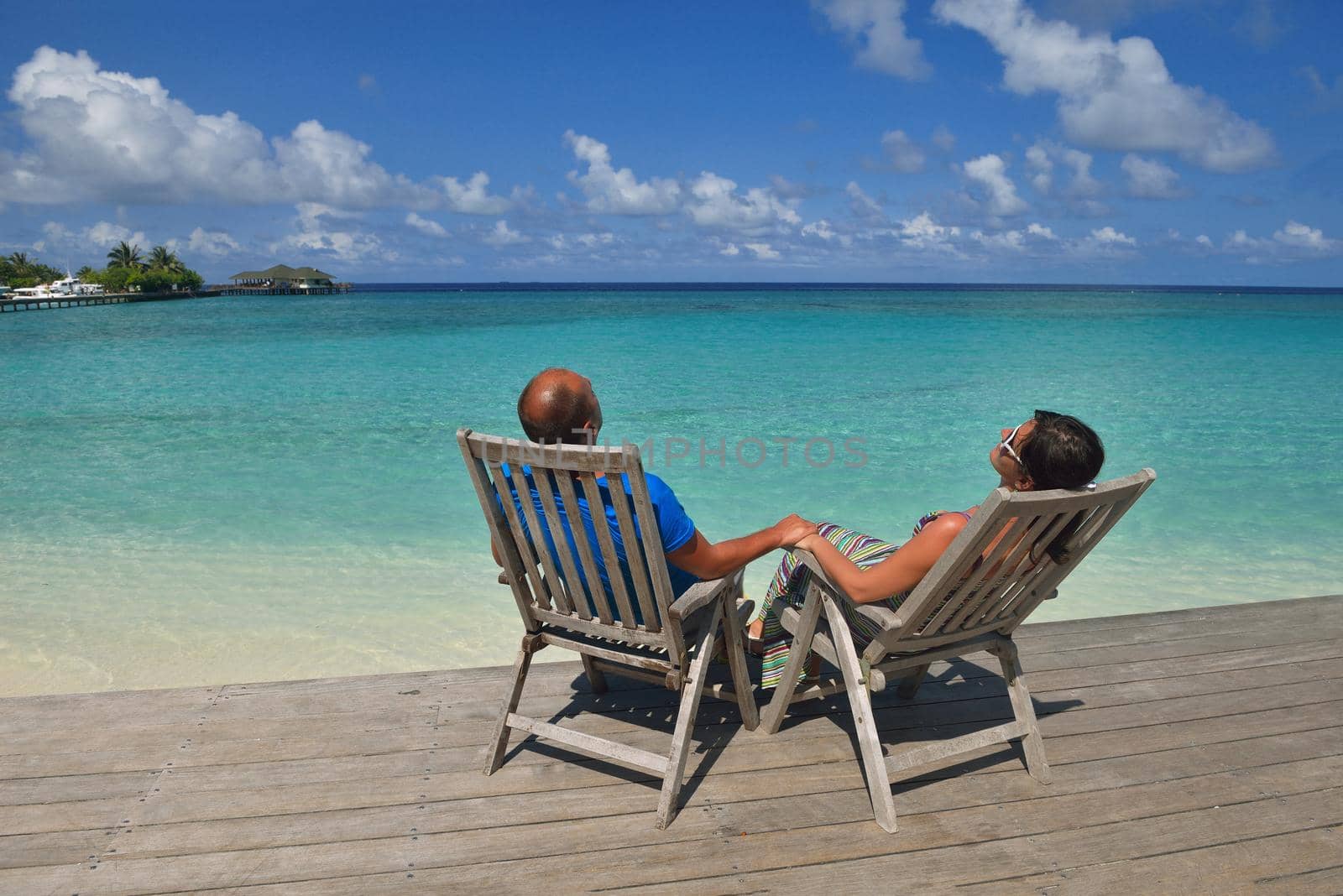 happy young couple have fun on beach by dotshock