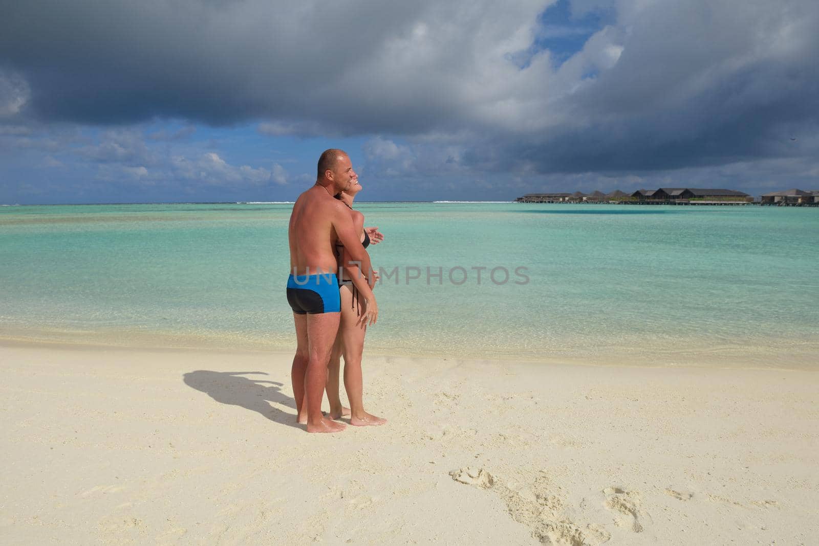 happy young romantic couple in love have fun running and relaxing on beautiful beach