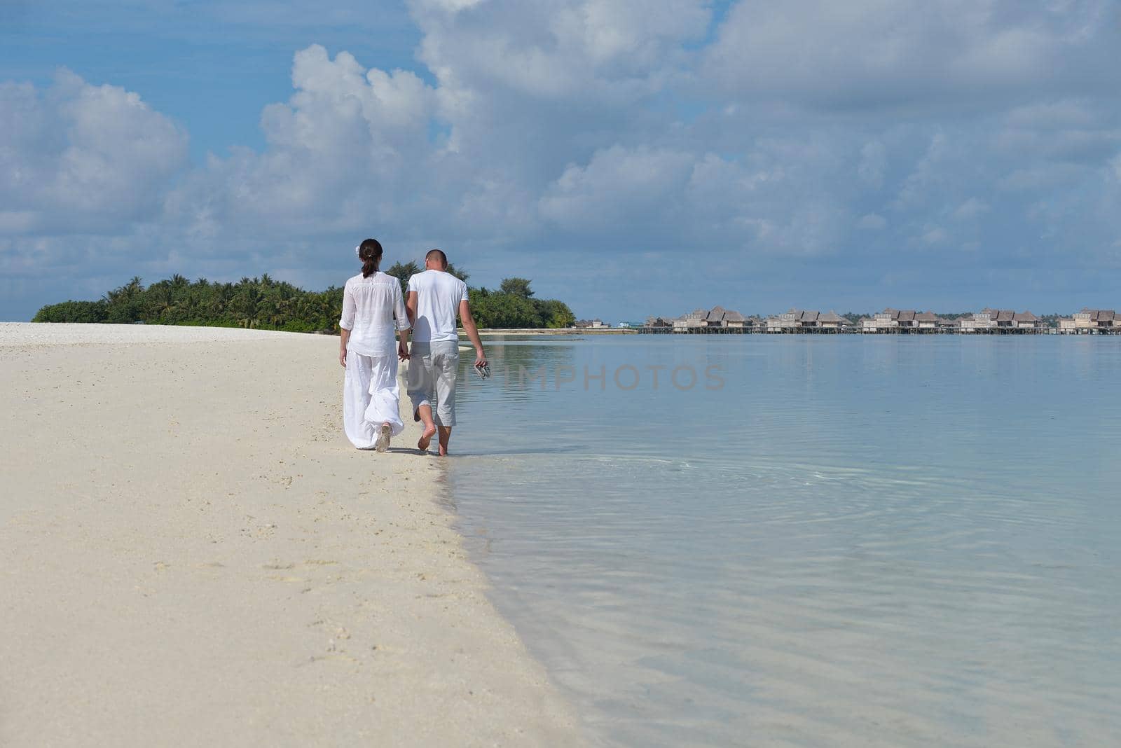 happy young romantic couple in love have fun running and relaxing on beautiful beach