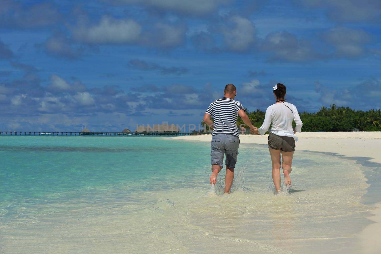 happy young romantic couple in love have fun running and relaxing on beautiful beach