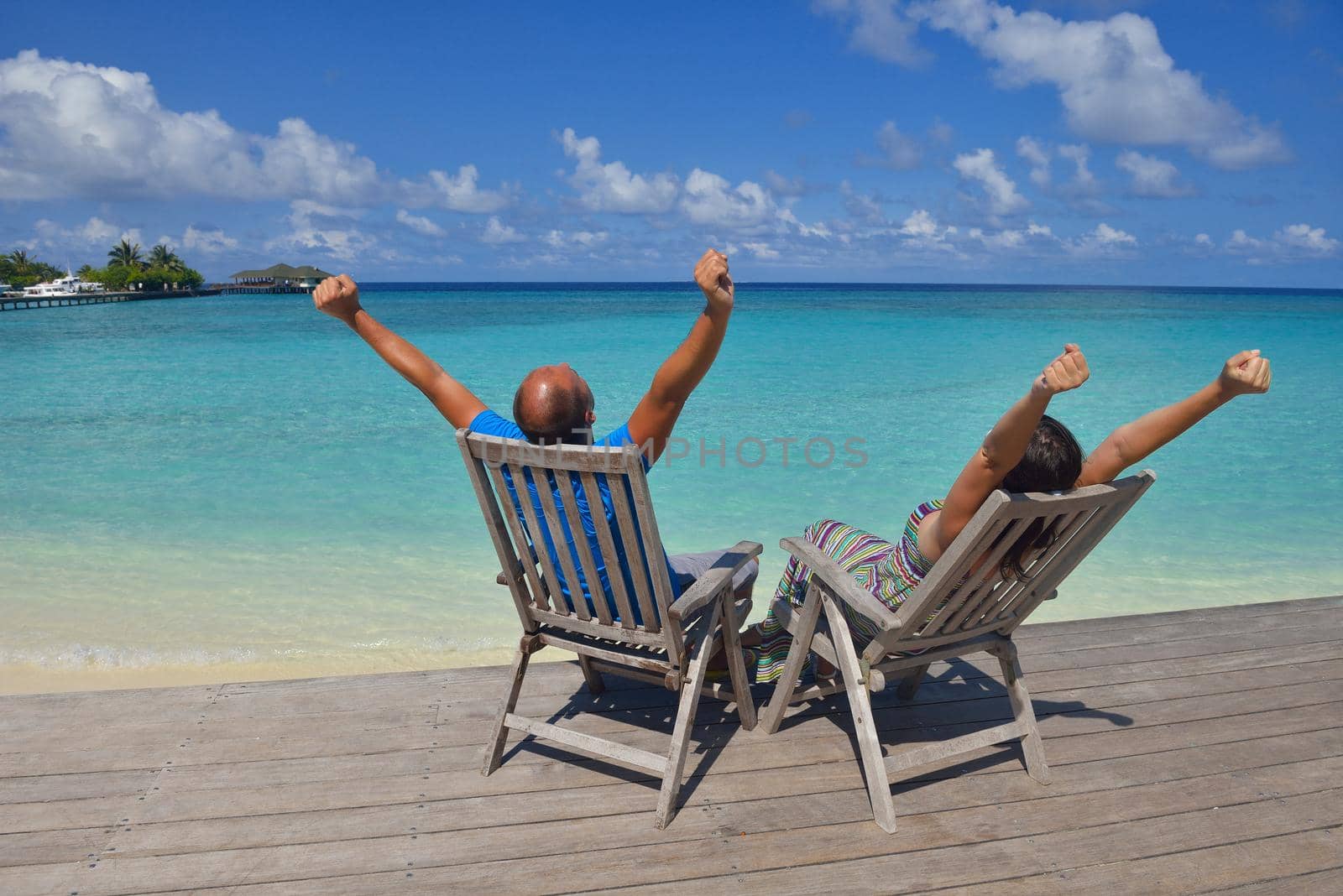 happy young couple have fun on beach by dotshock