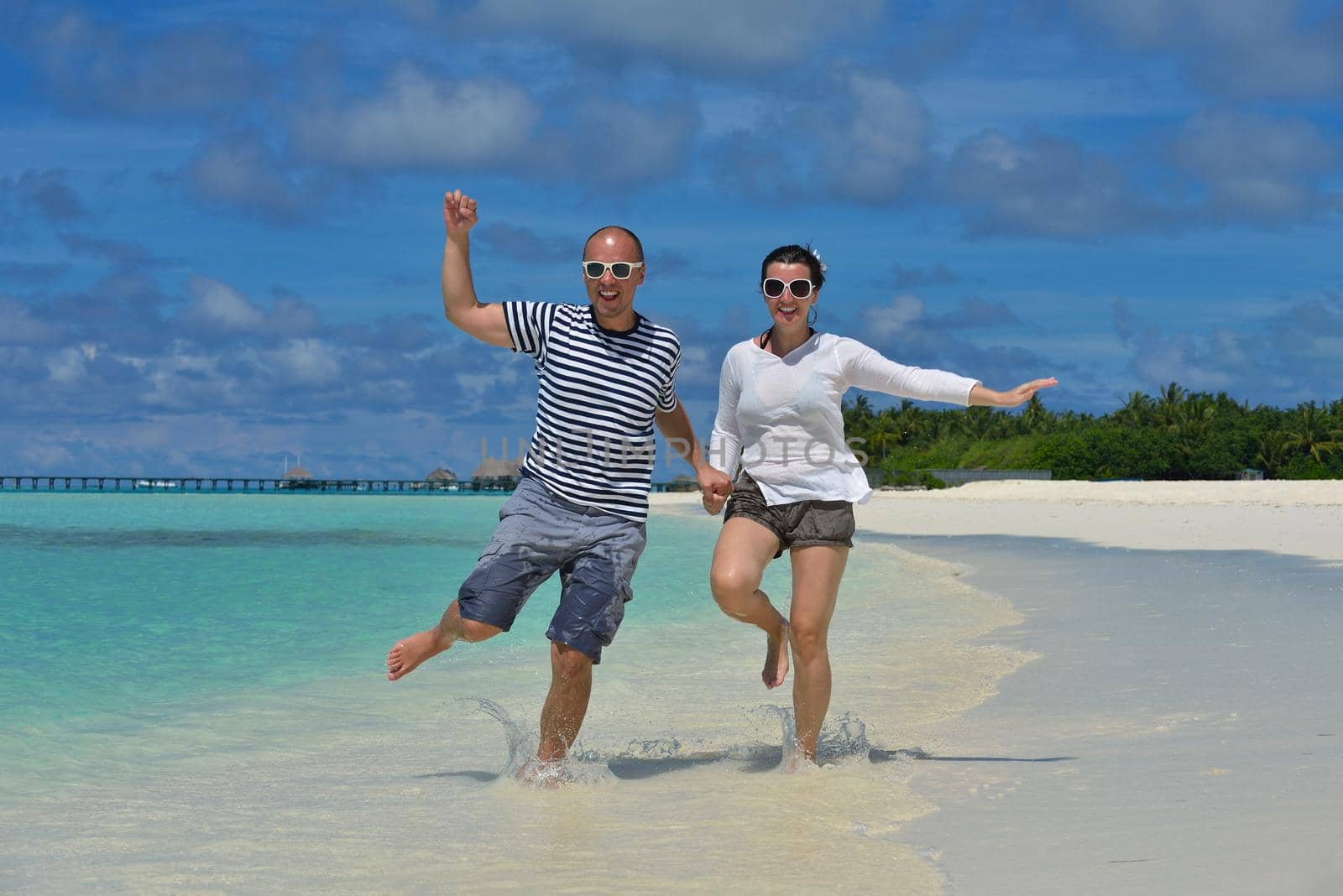 happy young romantic couple in love have fun running and relaxing on beautiful beach