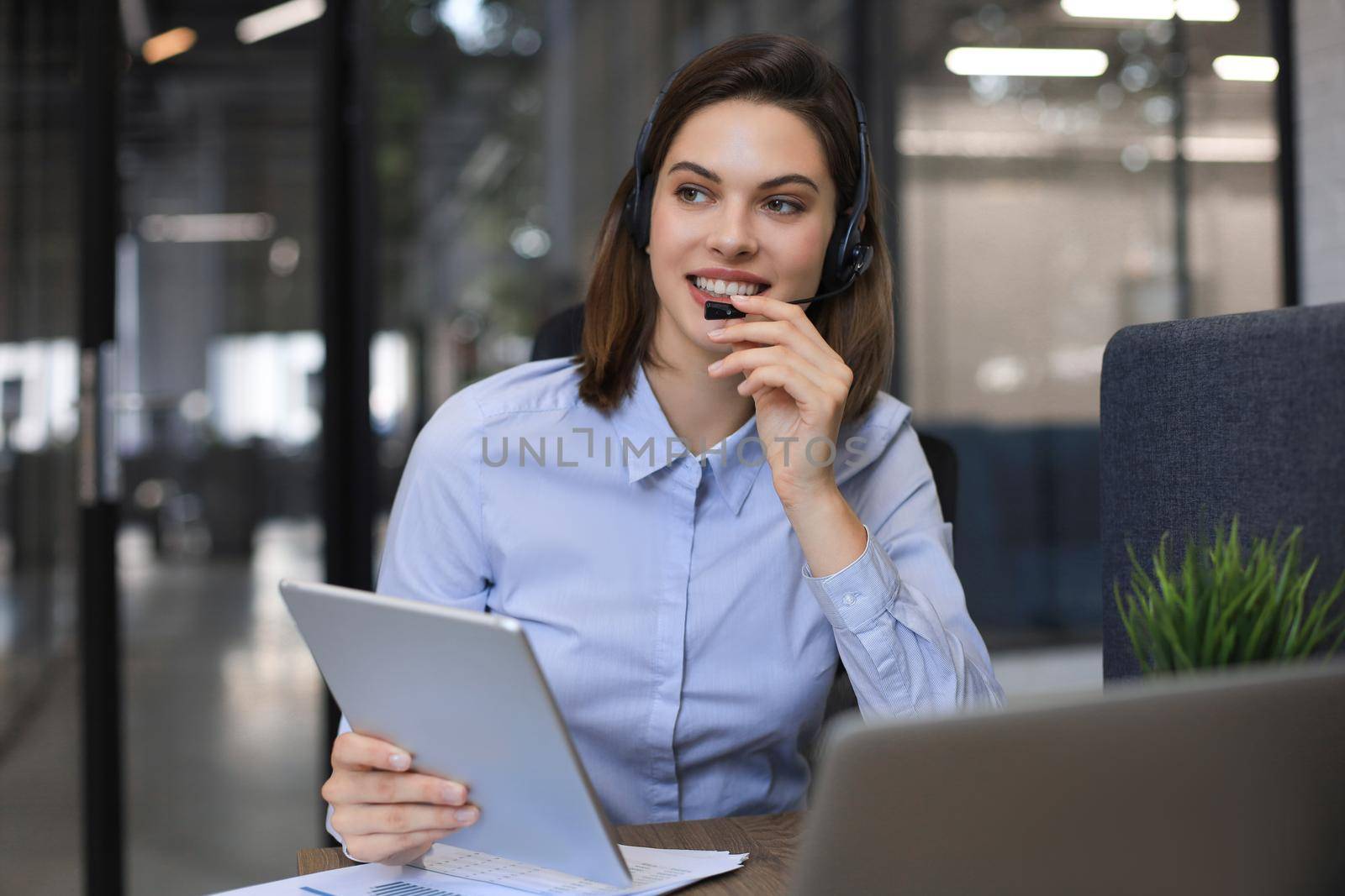 Freelance operator talking with headsets and consulting clients from office