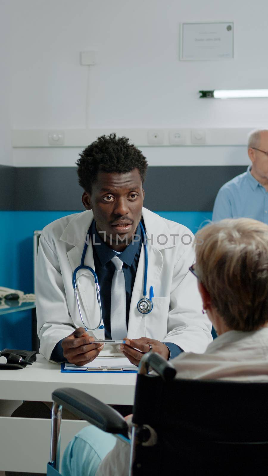 Elder patient with disability having checkup appointment by DCStudio