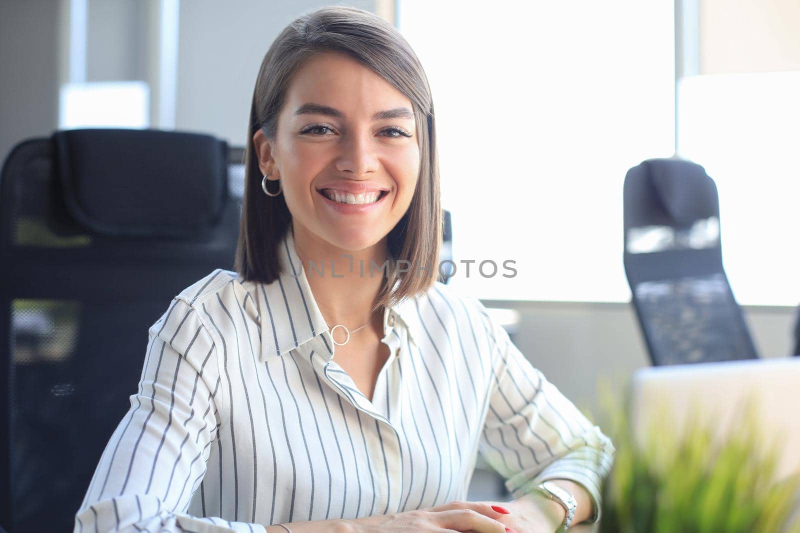 Young pretty businesswoman work on notebook computer in the bright modern office