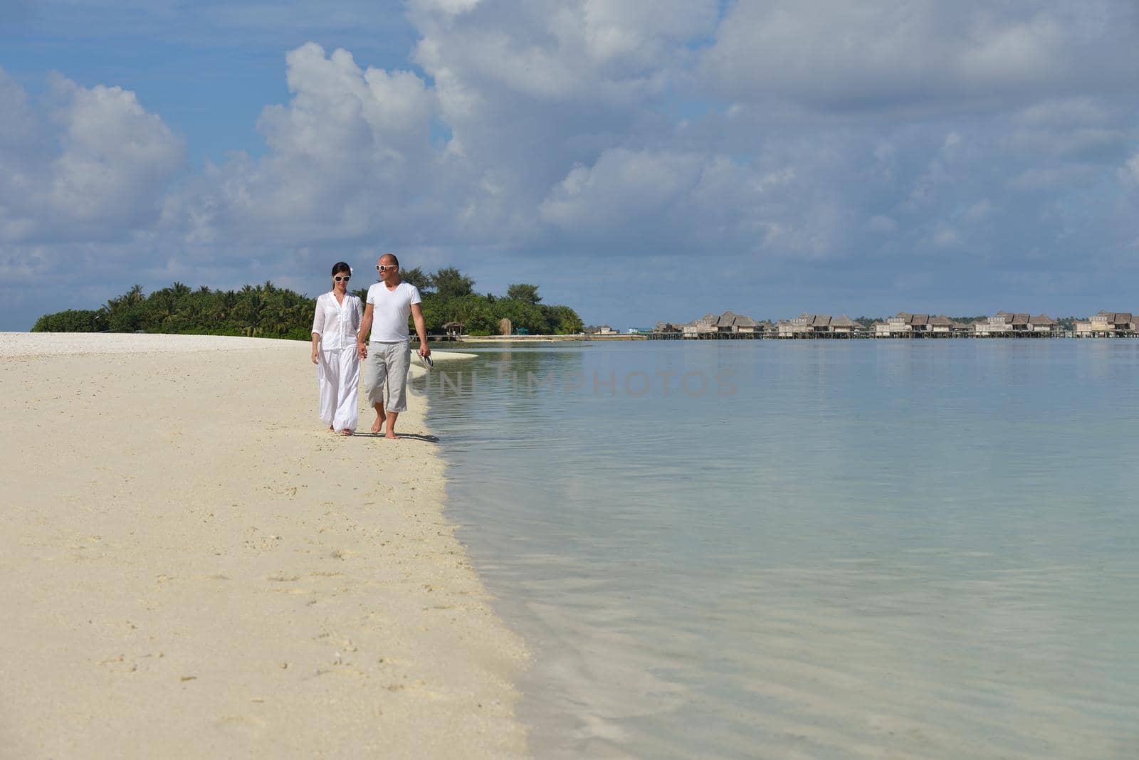 happy young couple have fun on beach by dotshock