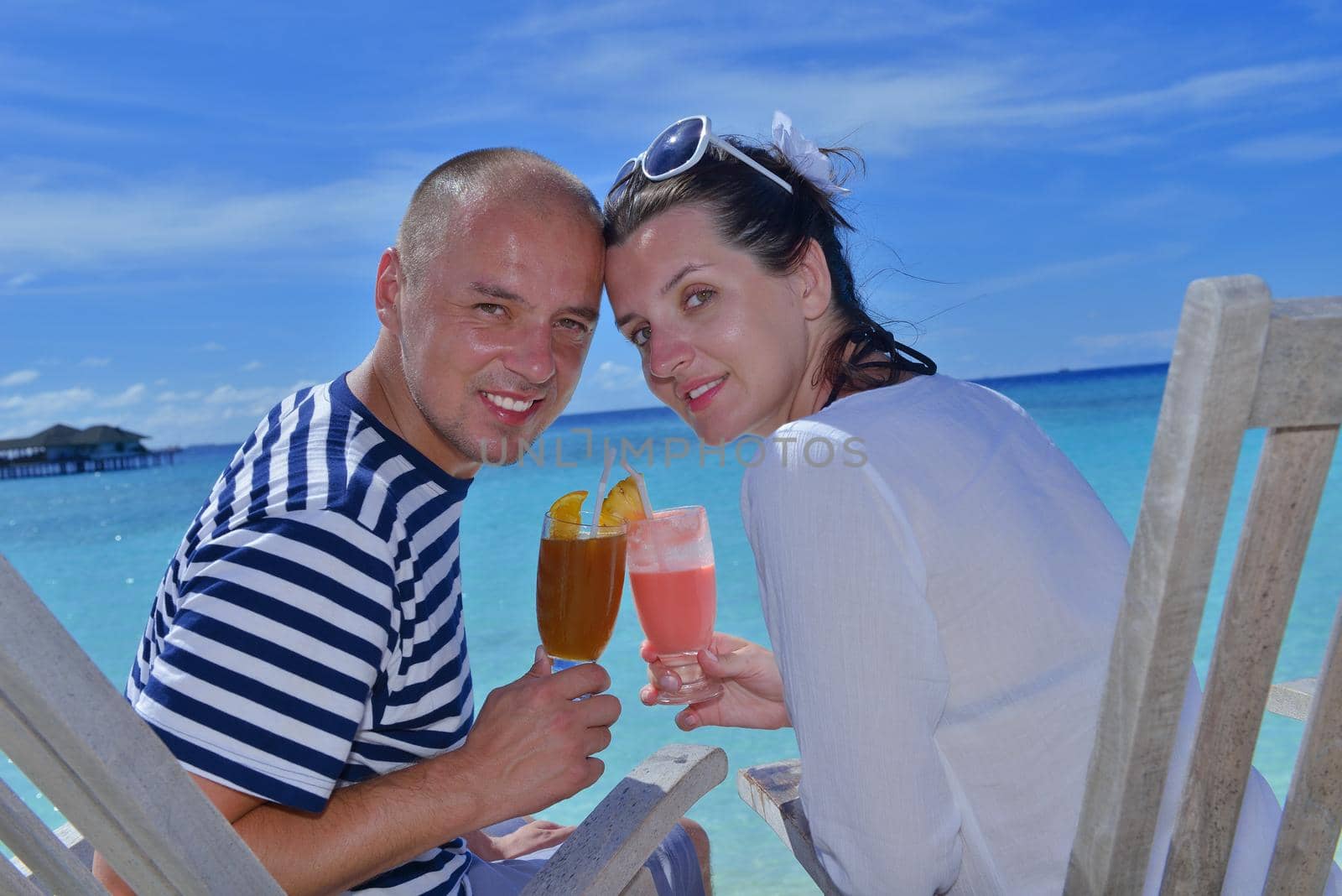 happy young couple relax and take fresh drink at summer vacation