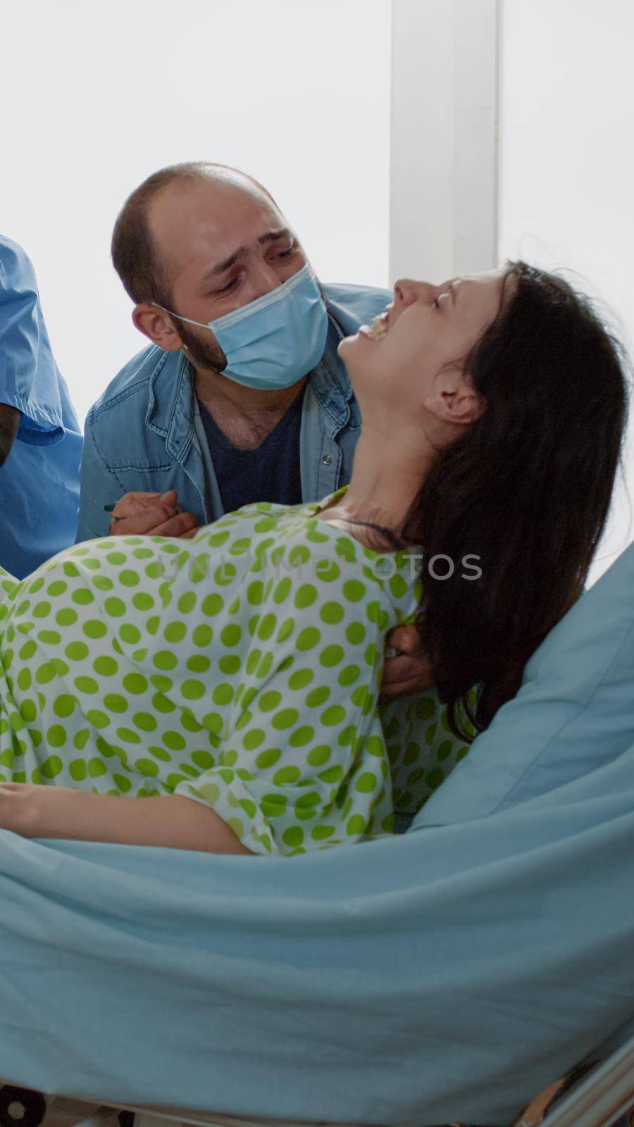 Obstetrician and african american nurse delivering baby by DCStudio