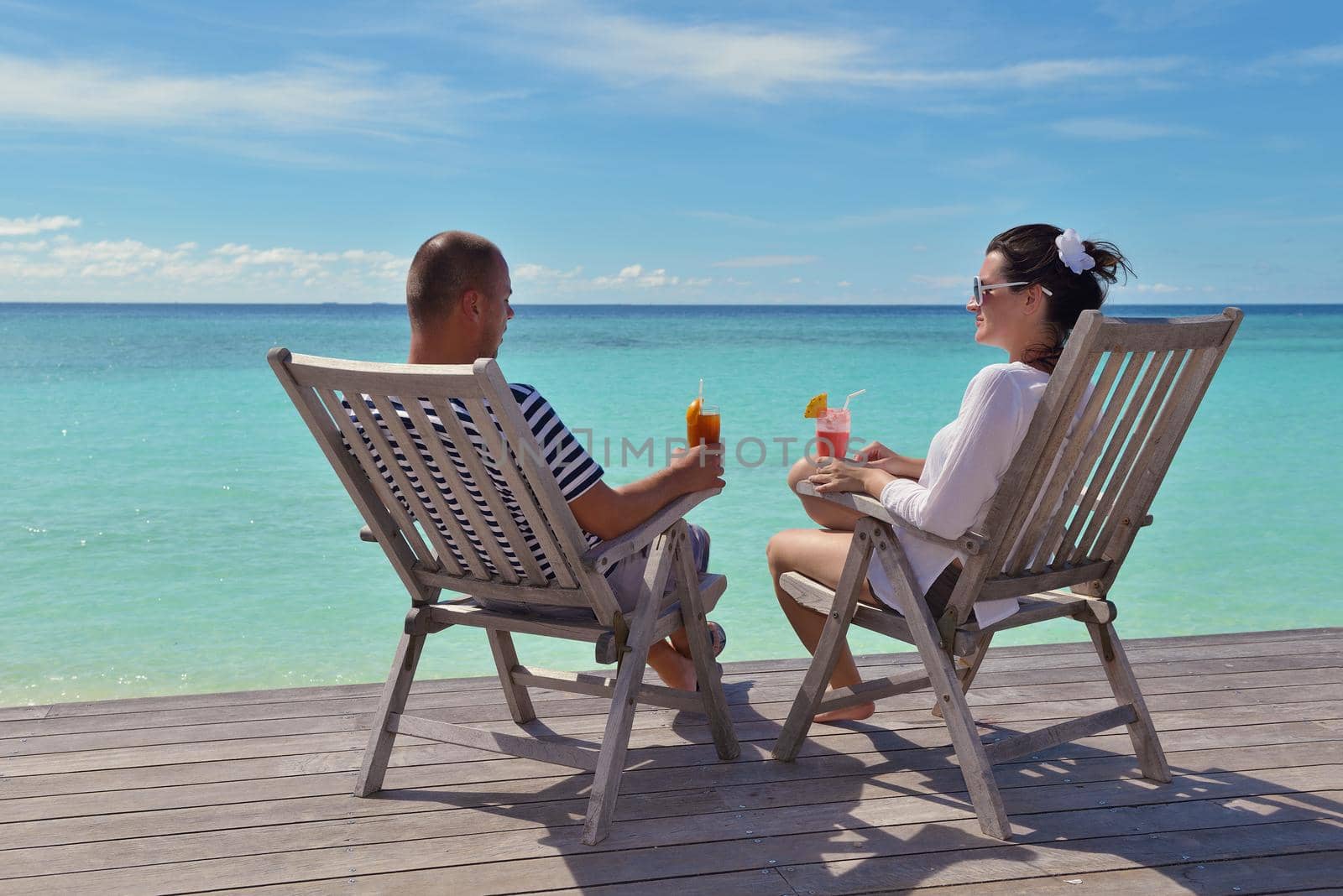 happy young couple relax and take fresh drink by dotshock