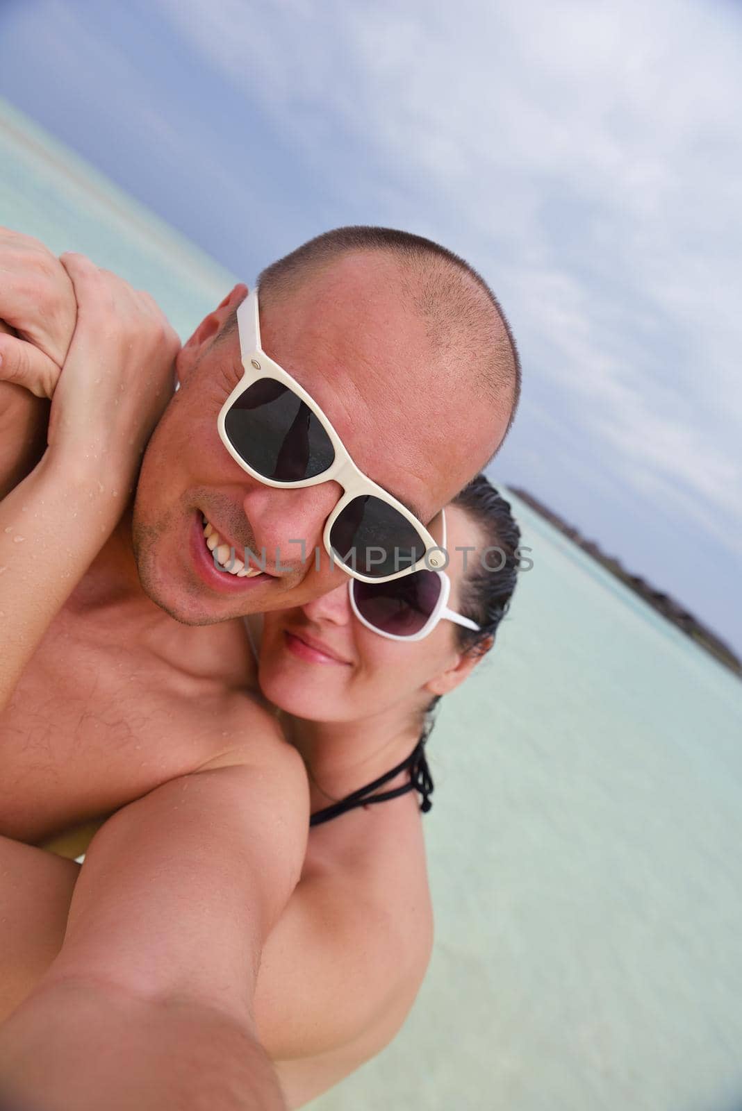 happy young  couple at summer vacation have fun and relax at beautiful sunny  day on beach