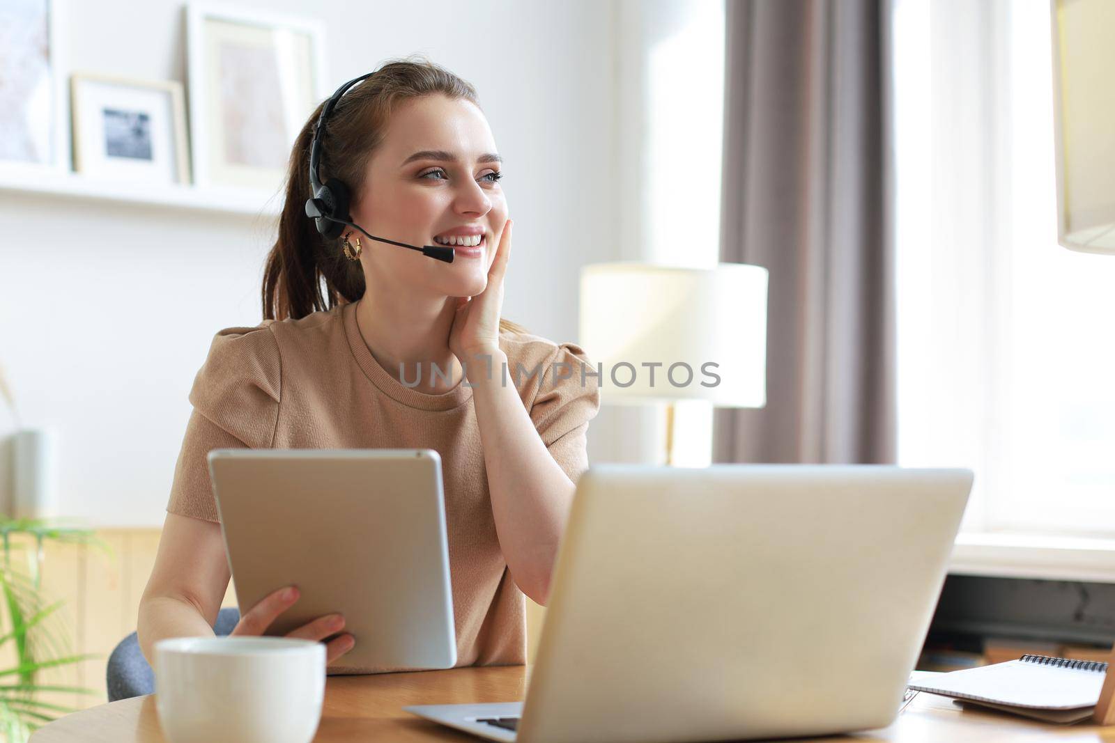 Freelance operator talking with headsets and consulting clients from home office