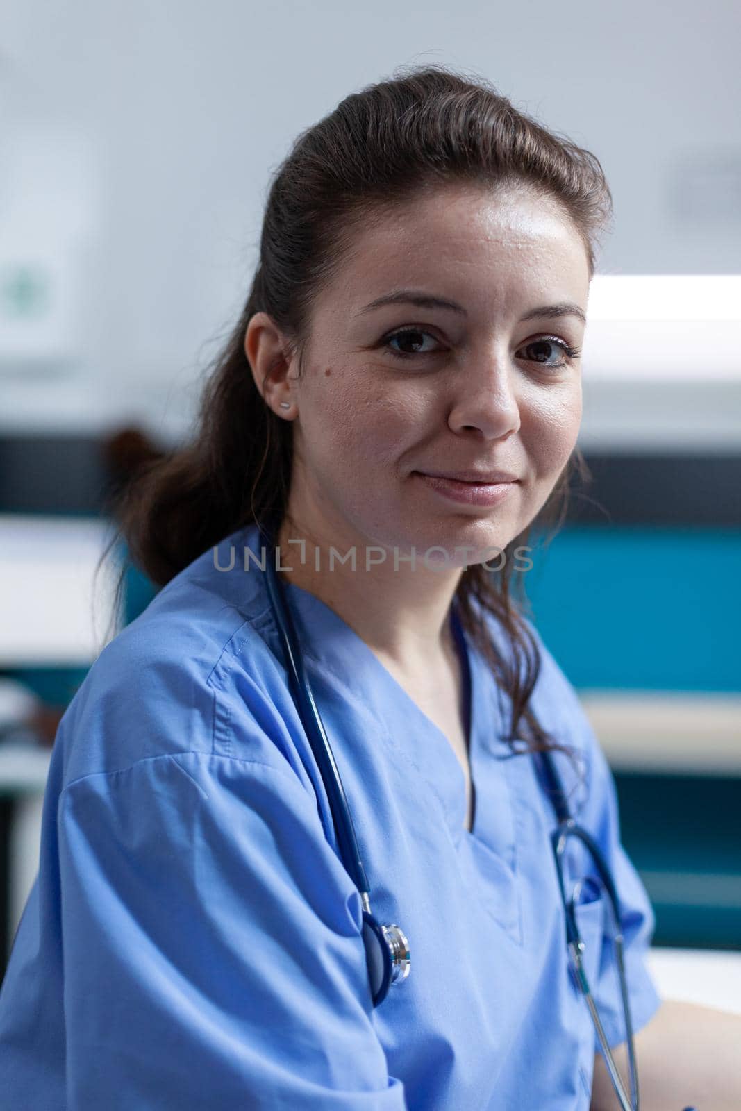 Portrait of practitioner nurse with medical stethoscope analyzing pharmaceutical prescription during clinical appointment in hospital office. Woman asisstance checking sickness symptoms