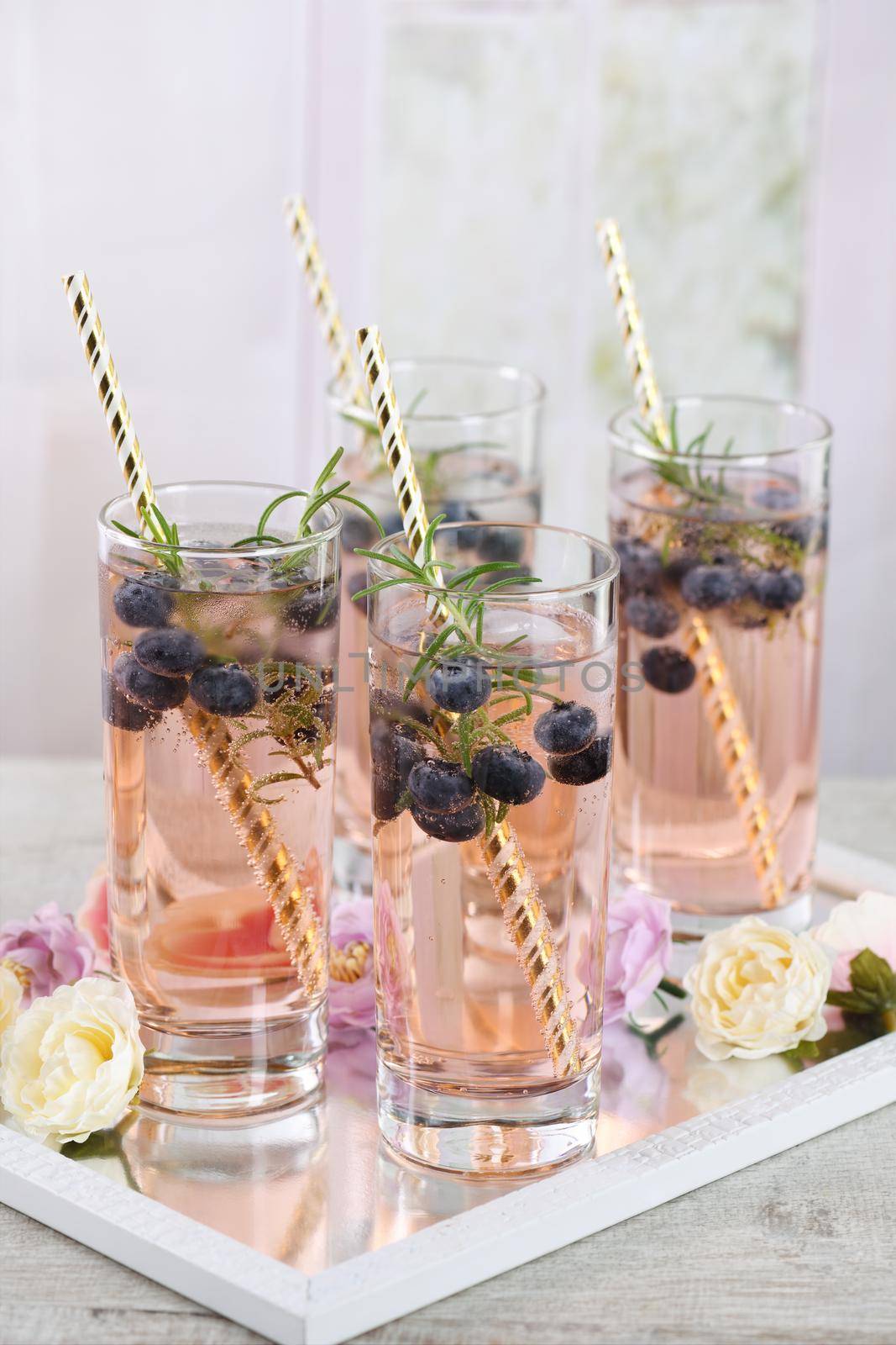 Cold shot in glass with blueberry, ice cubes, rosemary. Celebratory inspiration in Provence style