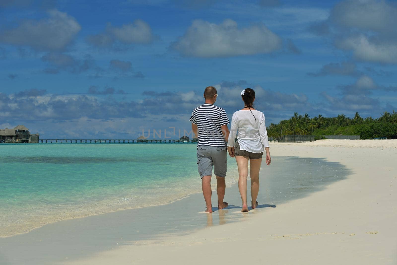 happy young romantic couple in love have fun running and relaxing on beautiful beach