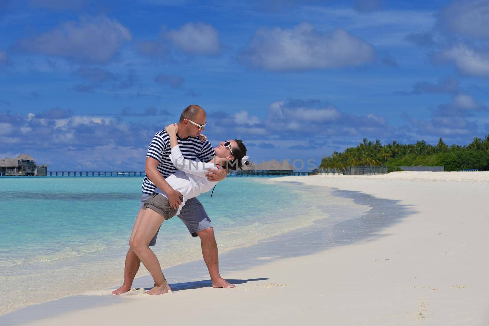 happy young  couple at summer vacation have fun and relax at beautiful sunny  day on beach