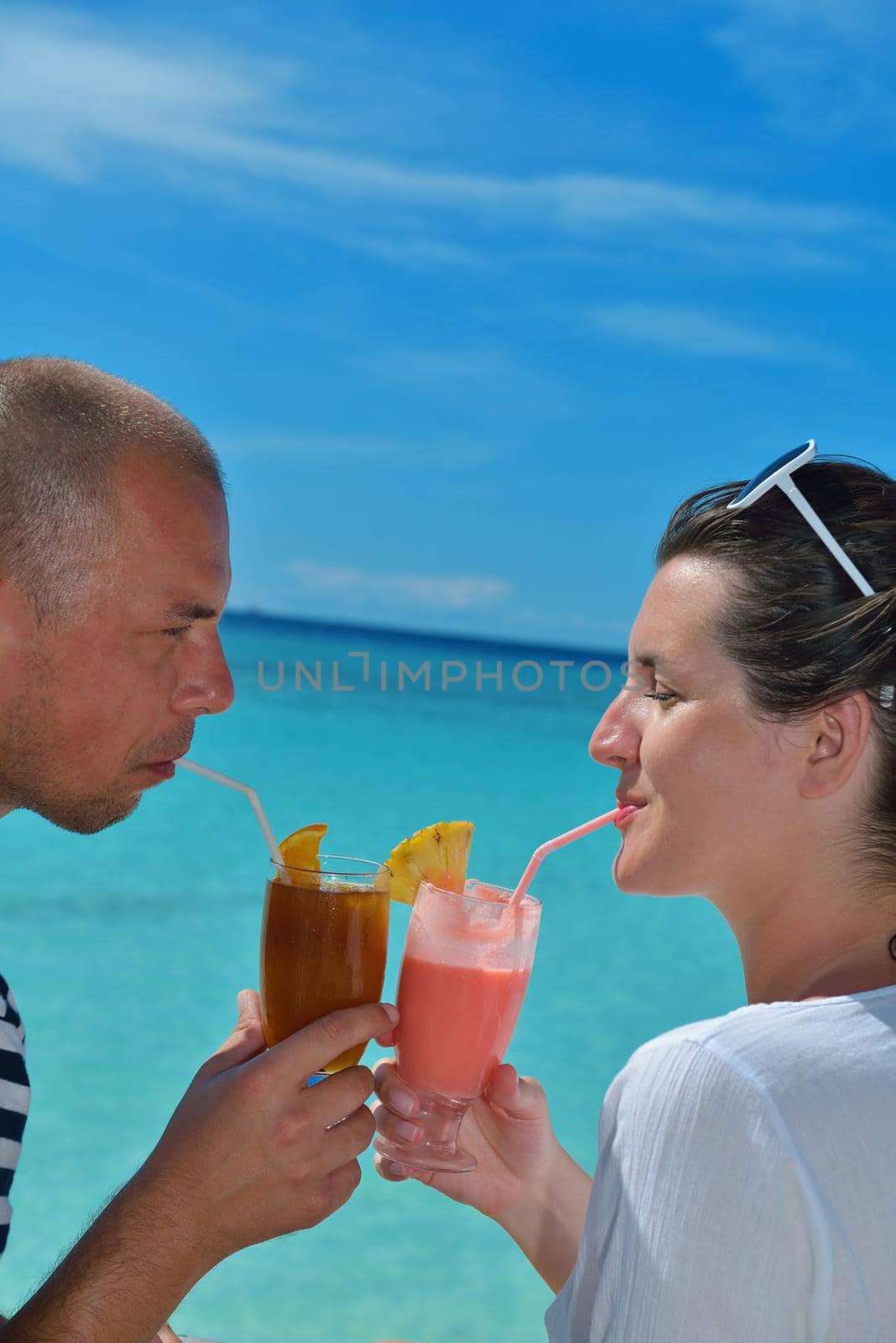 happy young couple relax and take fresh drink at summer vacation