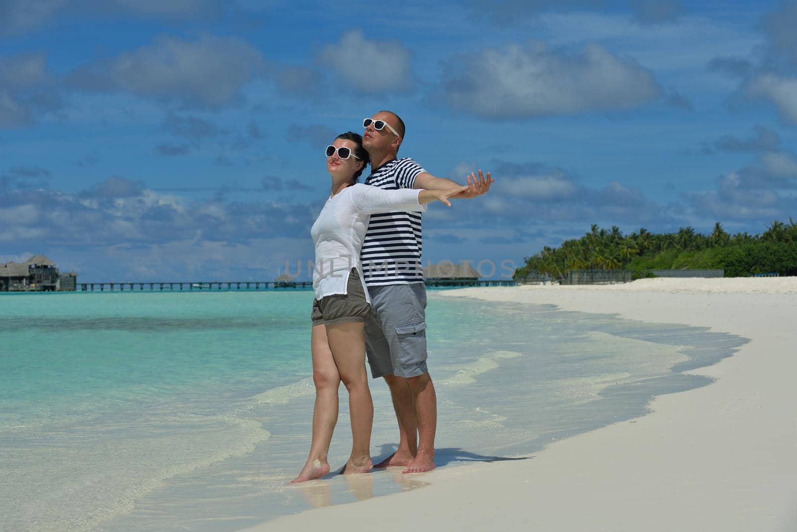 happy young romantic couple in love have fun running and relaxing on beautiful beach