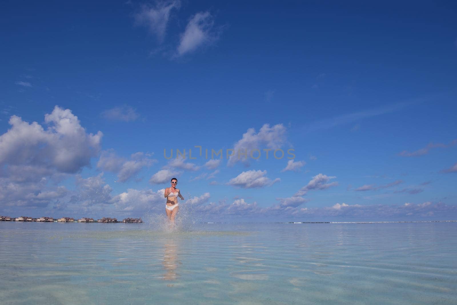 happy young woman on summer vacation on beautiful tropical beach have fun enjoy and relax