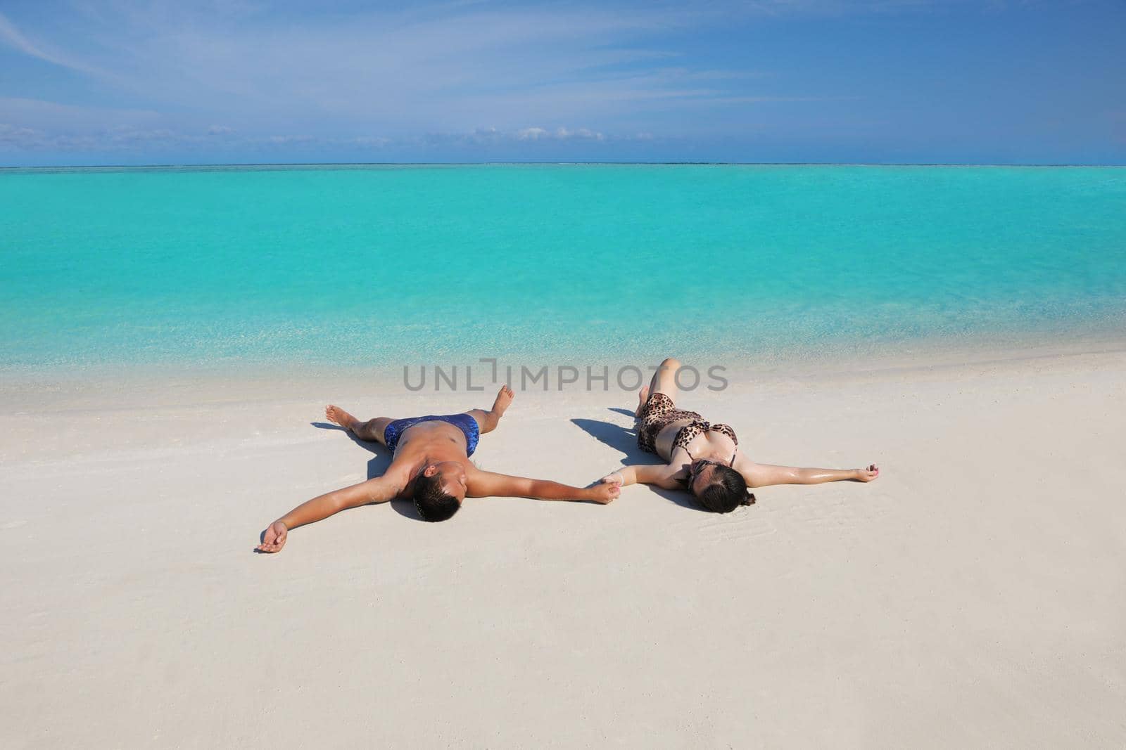 happy young asian couple enjoying summer and have on beautiful white sand beach