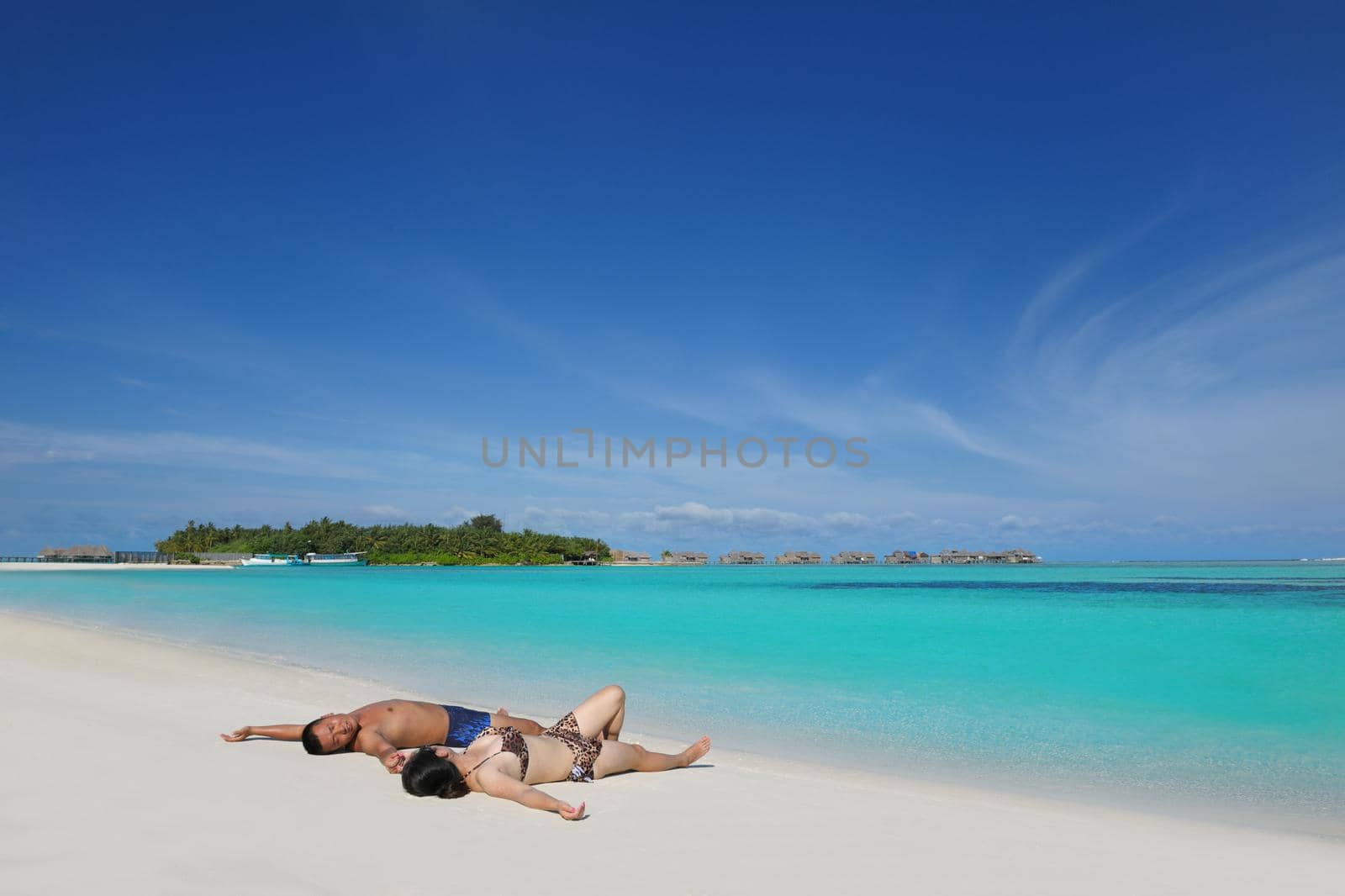 happy young asian couple have fun and romantic time at  summer on beautiful white sand beach