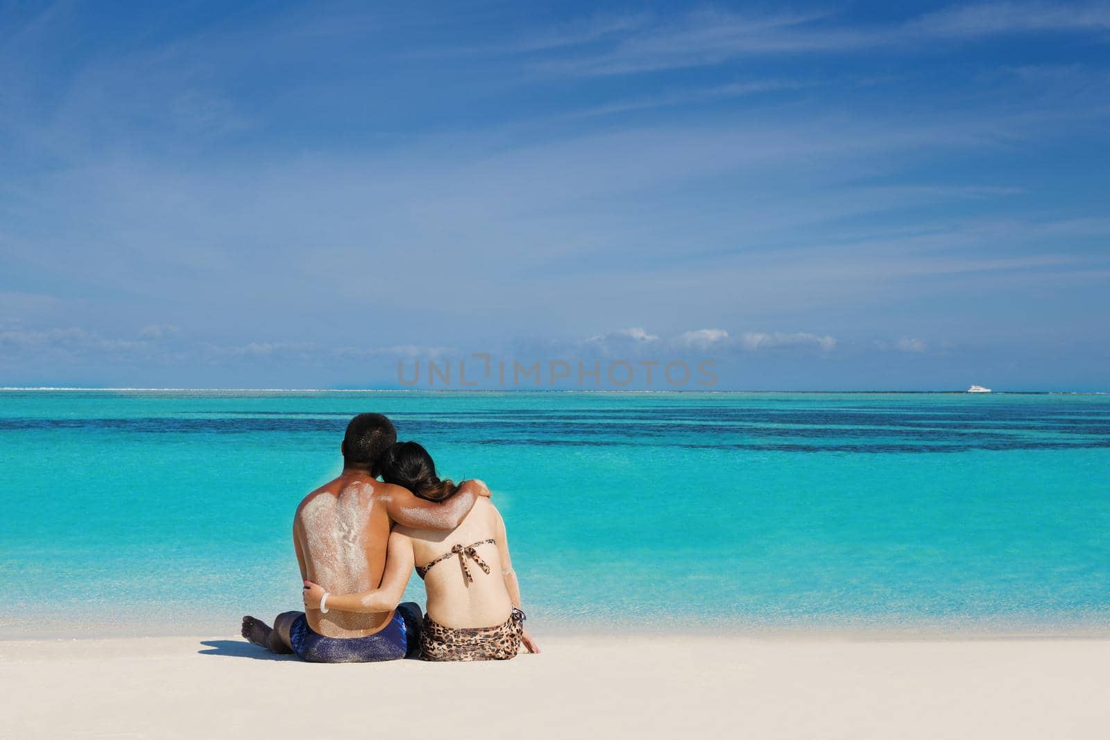 happy young  couple enjoying summer on beach by dotshock