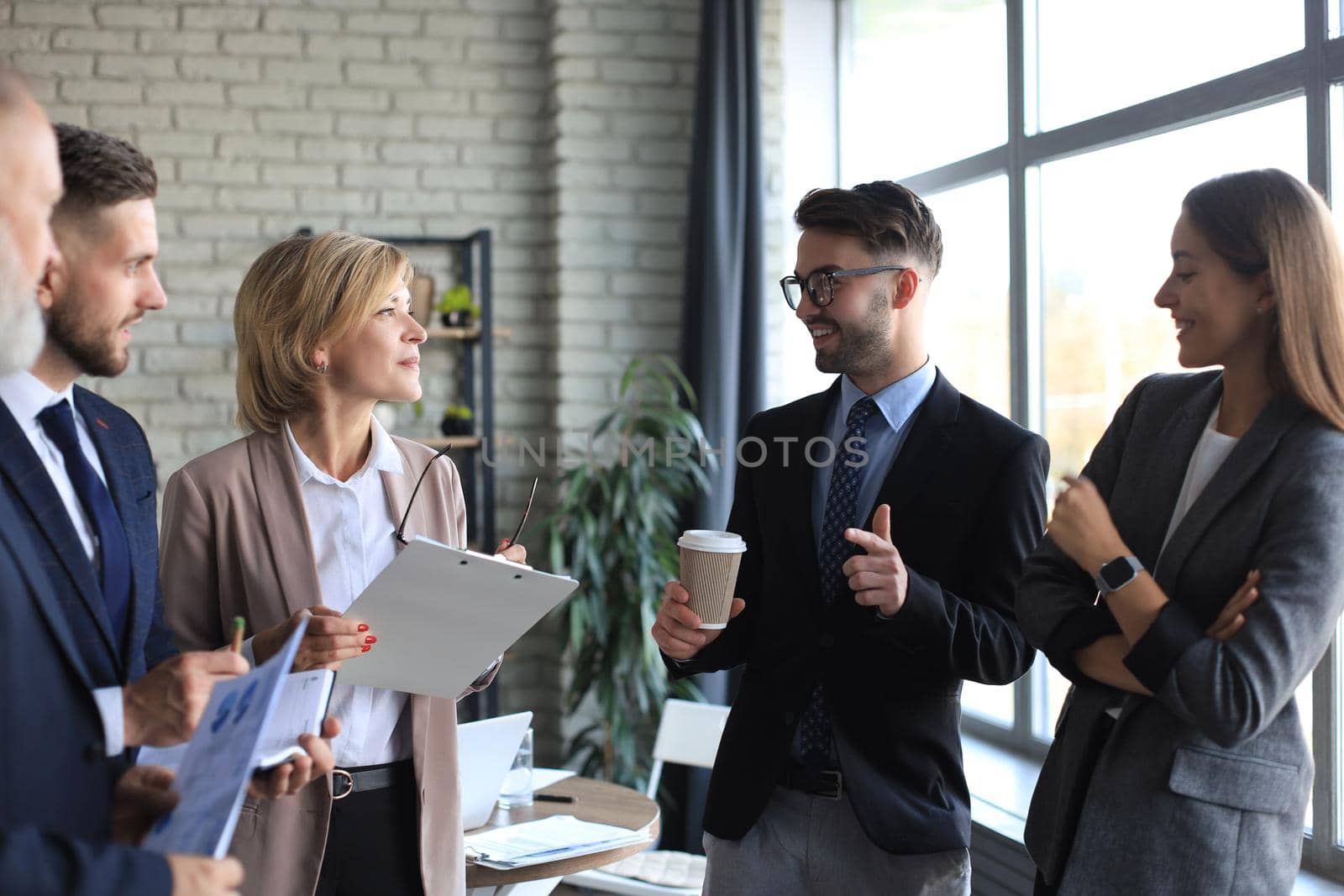 Group of business partners discussing ideas and planning work in office