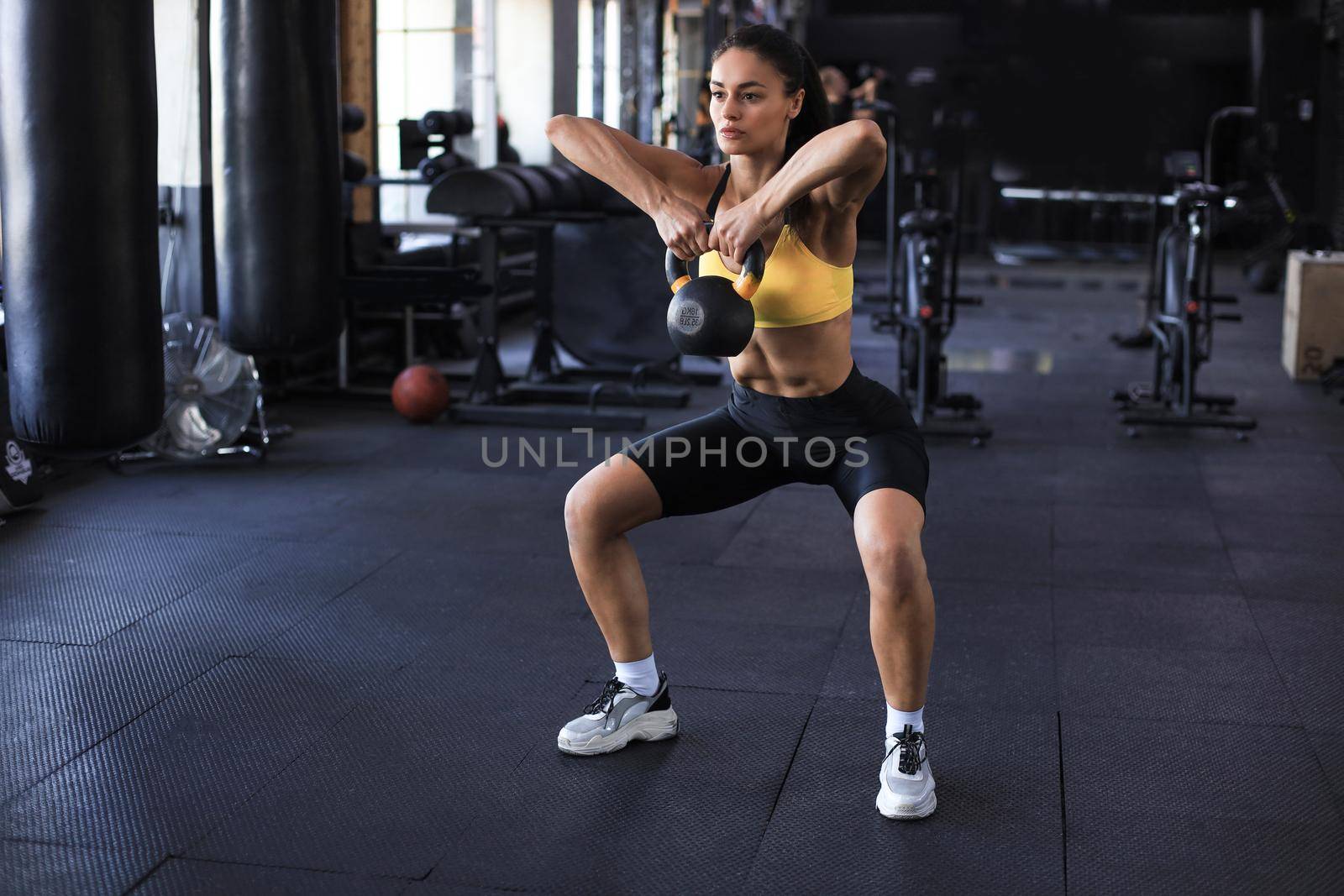 sport woman with kettlebell in the gym