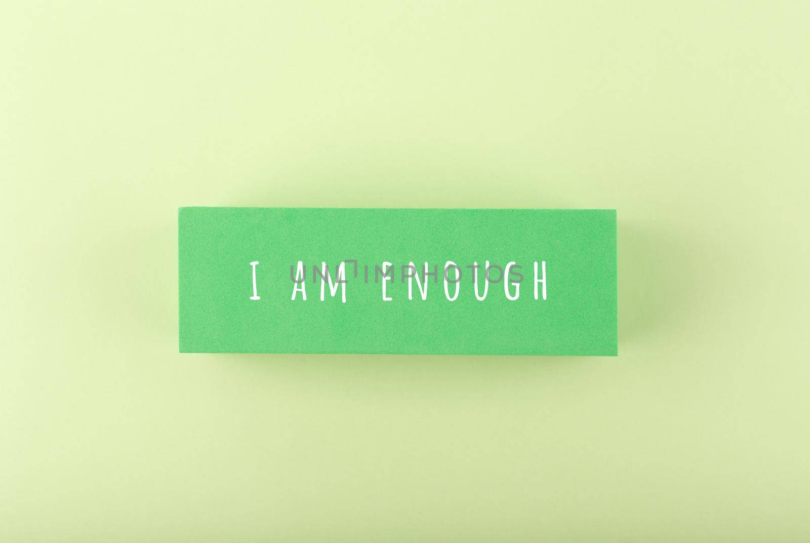 I am enough concept on bright pastel green background. Lettering design for positive, motivation quote, mental health, self love and body positive