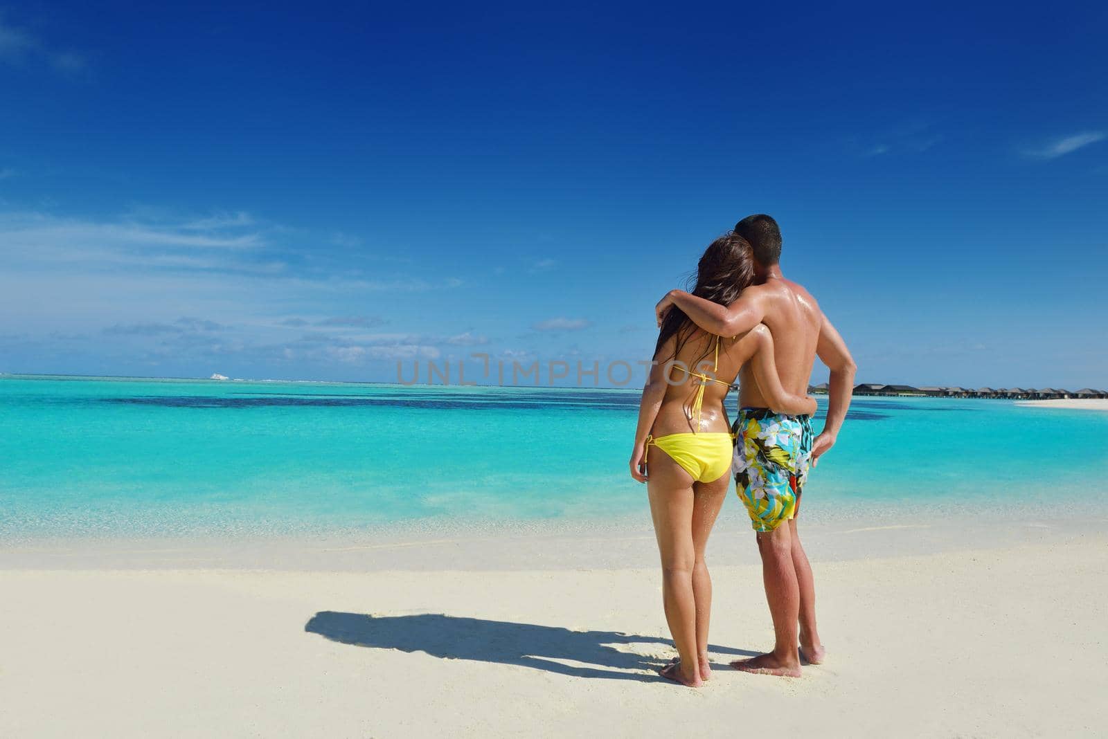 happy young asian couple have fun and romantic time at  summer on beautiful white sand beach